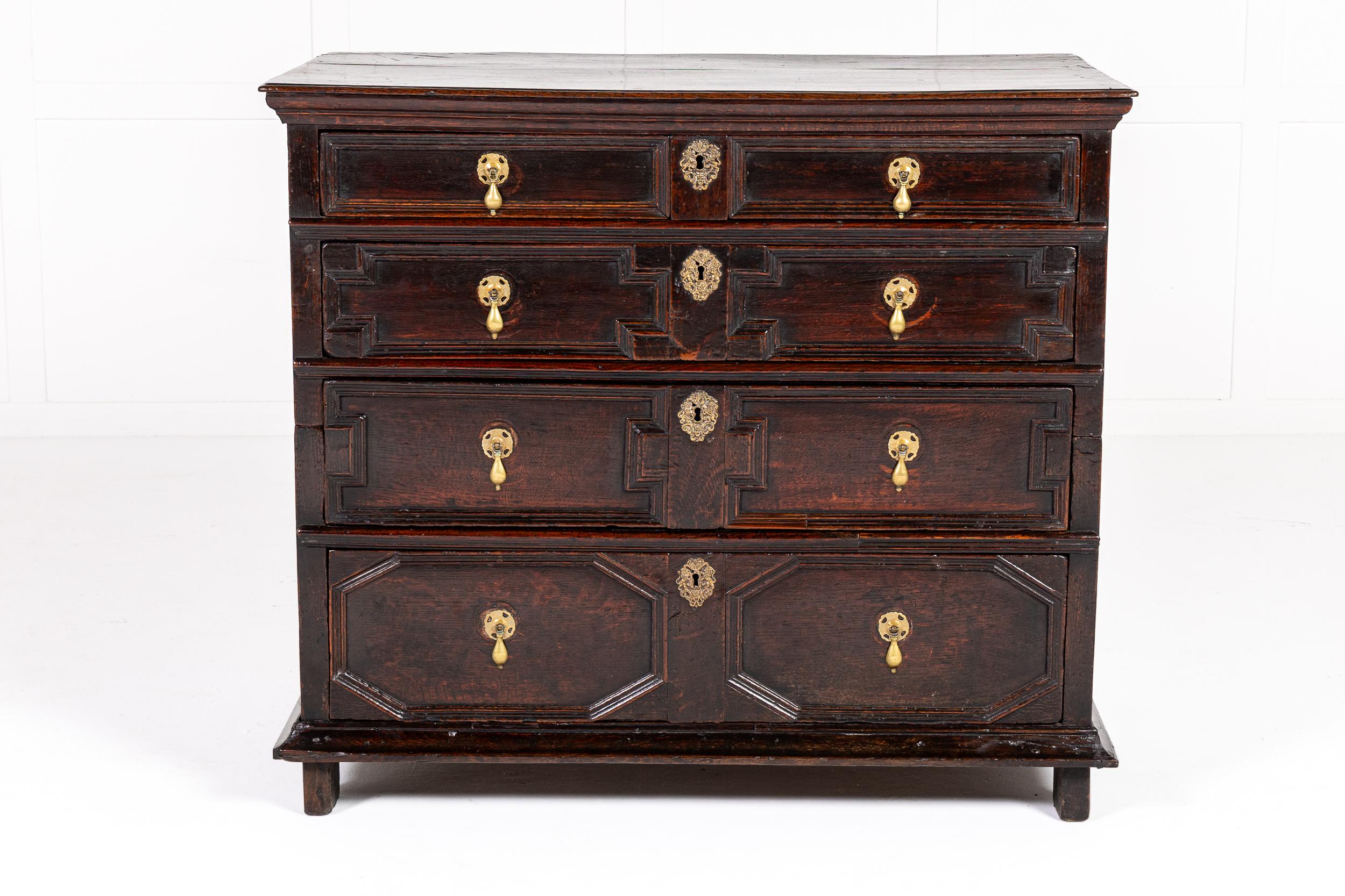 A Handsome 17th Century Oak Chest of Drawers in Two Sections.

Made in two sections for ease of transport, the piece has a moulded overhanging top above four graduated drawers, each drawer front having differently shaped panelled carving in deep