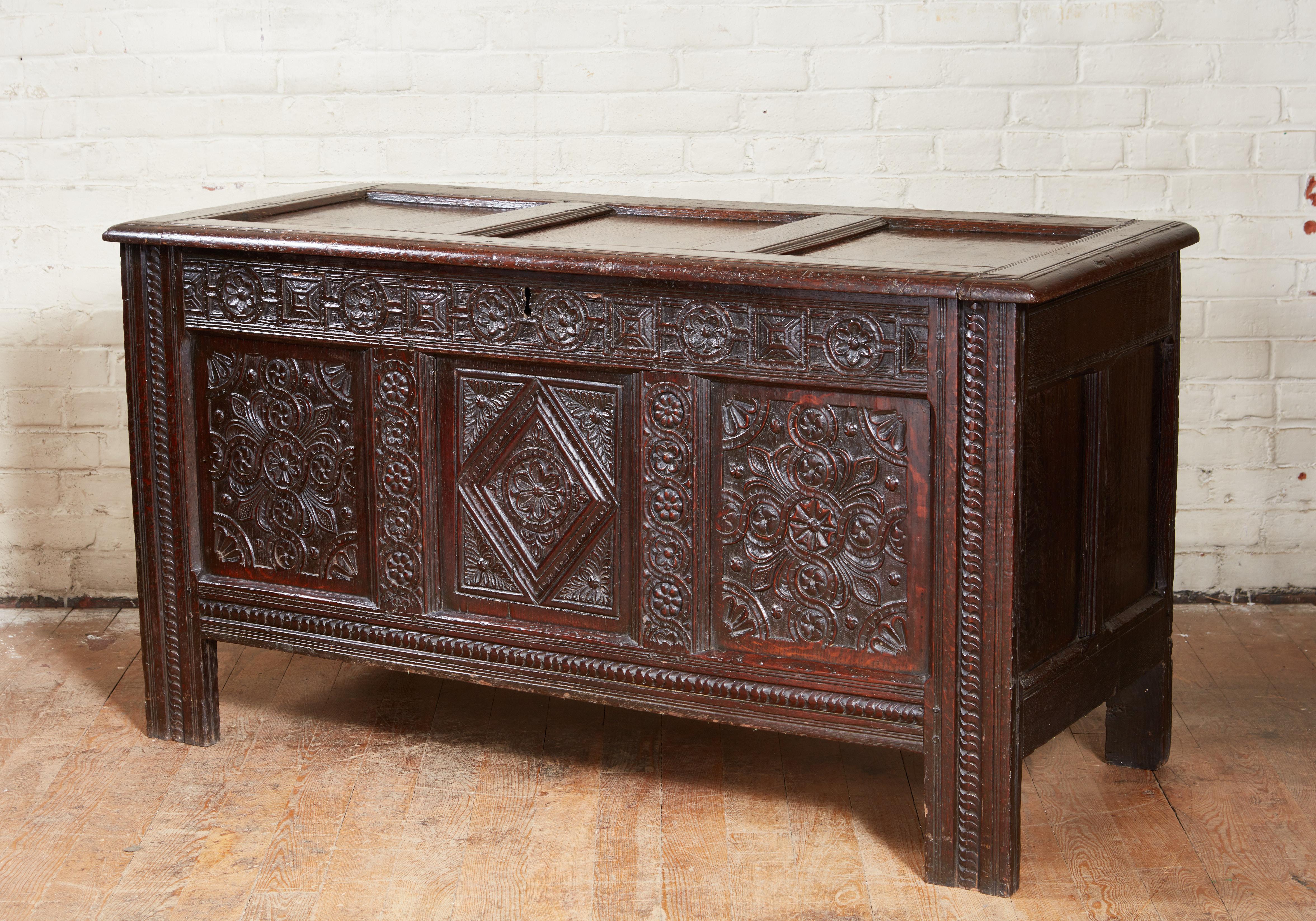 Very fine 17th century English oak coffer, the paneled top with molded stiles and rails over panel front with profusely geometric carved panels, stiles and rails the whole possessing very good rich color and in remarkably original condition.