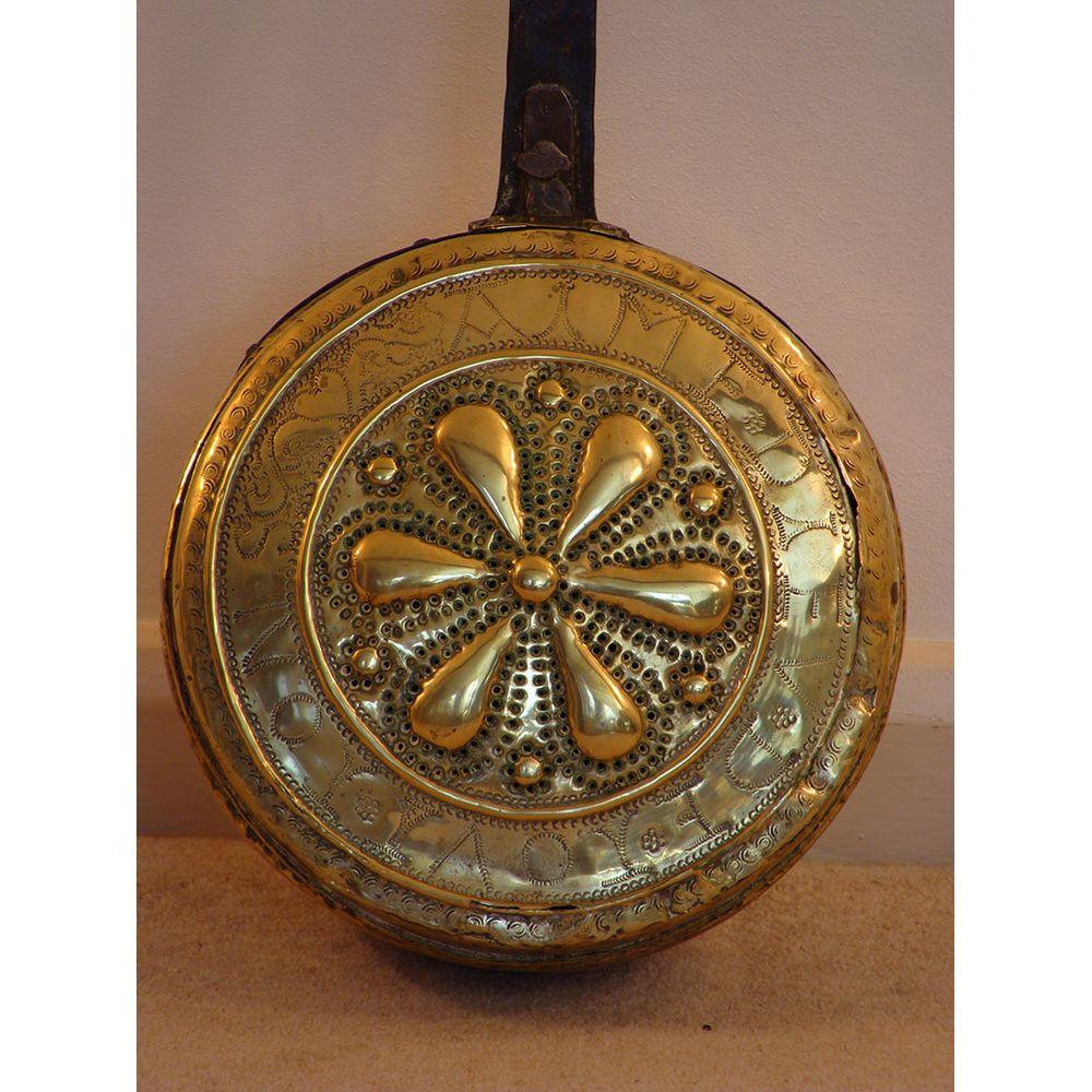 A rare English 17th century pierced-brass plague pan.
It retains its original wrought-iron handle and is in excellent condition.

Further research reveals the inscription to have been written on this antique pan in Middle (Old) French. 
It reads