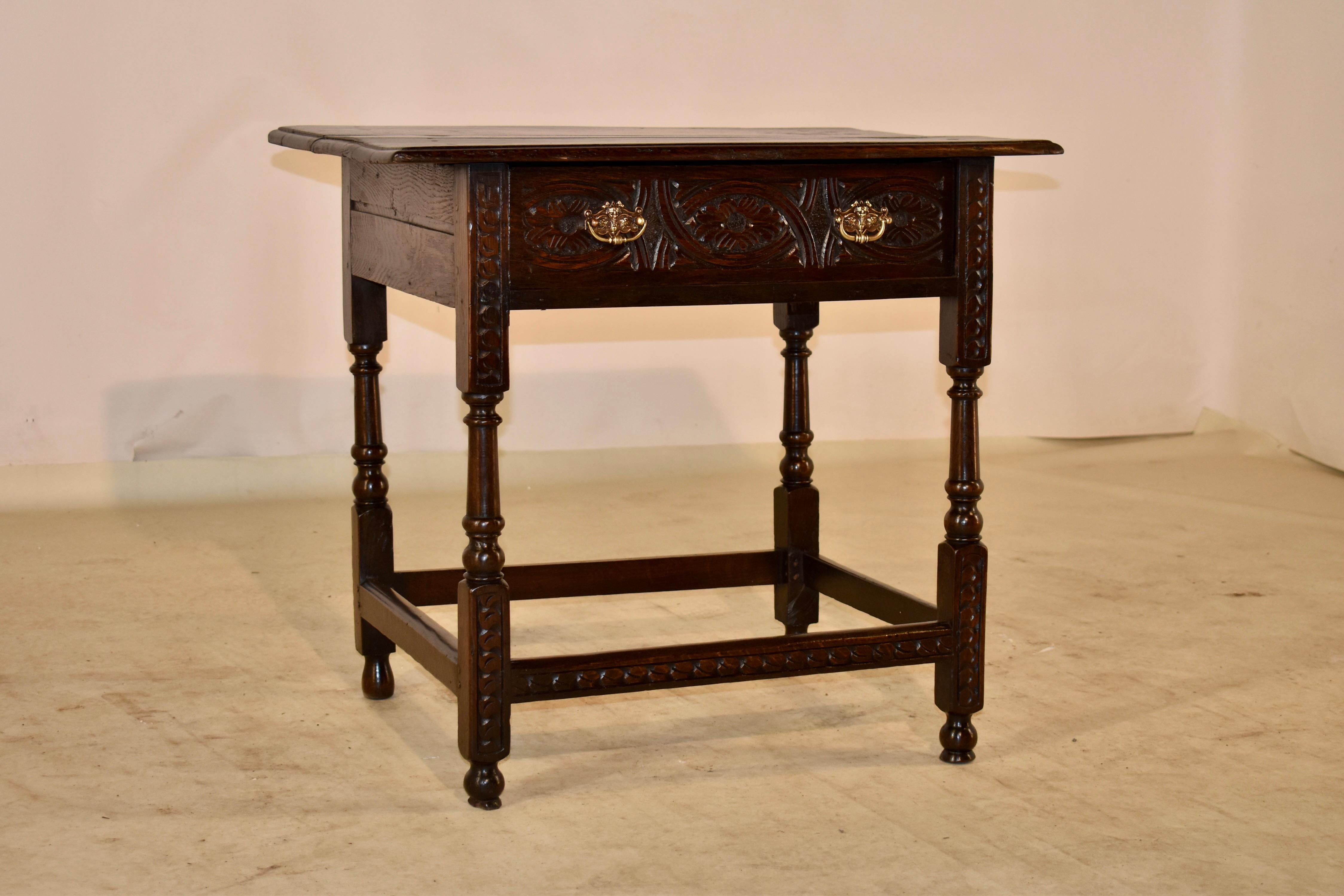 17th Century oak side table from England. The top is made from nicely grained planks and have a beveled edge, following down to simple sides and a single drawer in the front with a hand carved drawer front. The table is supported on hand turned and