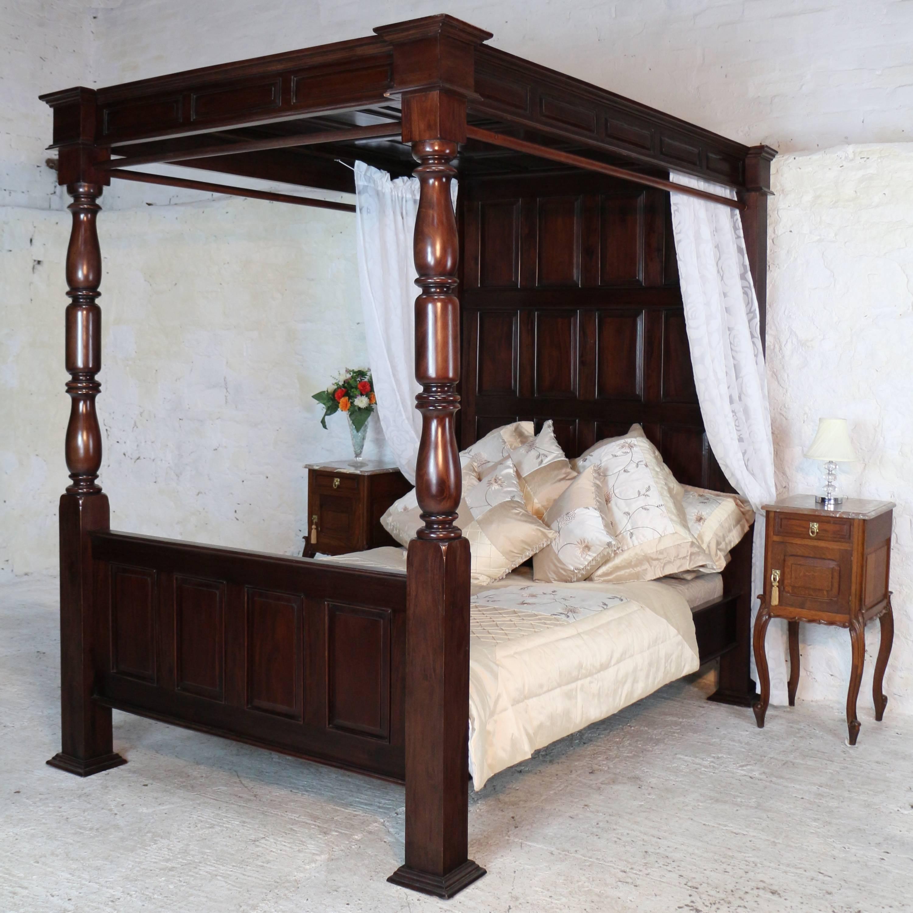 A handsome 17th century style dark mahogany four-poster tester bed with a fielded panelled cornice and canopy ceiling. With turned columns to the foot and a panelled headboard set between square section uprights it is also fitted with poles for