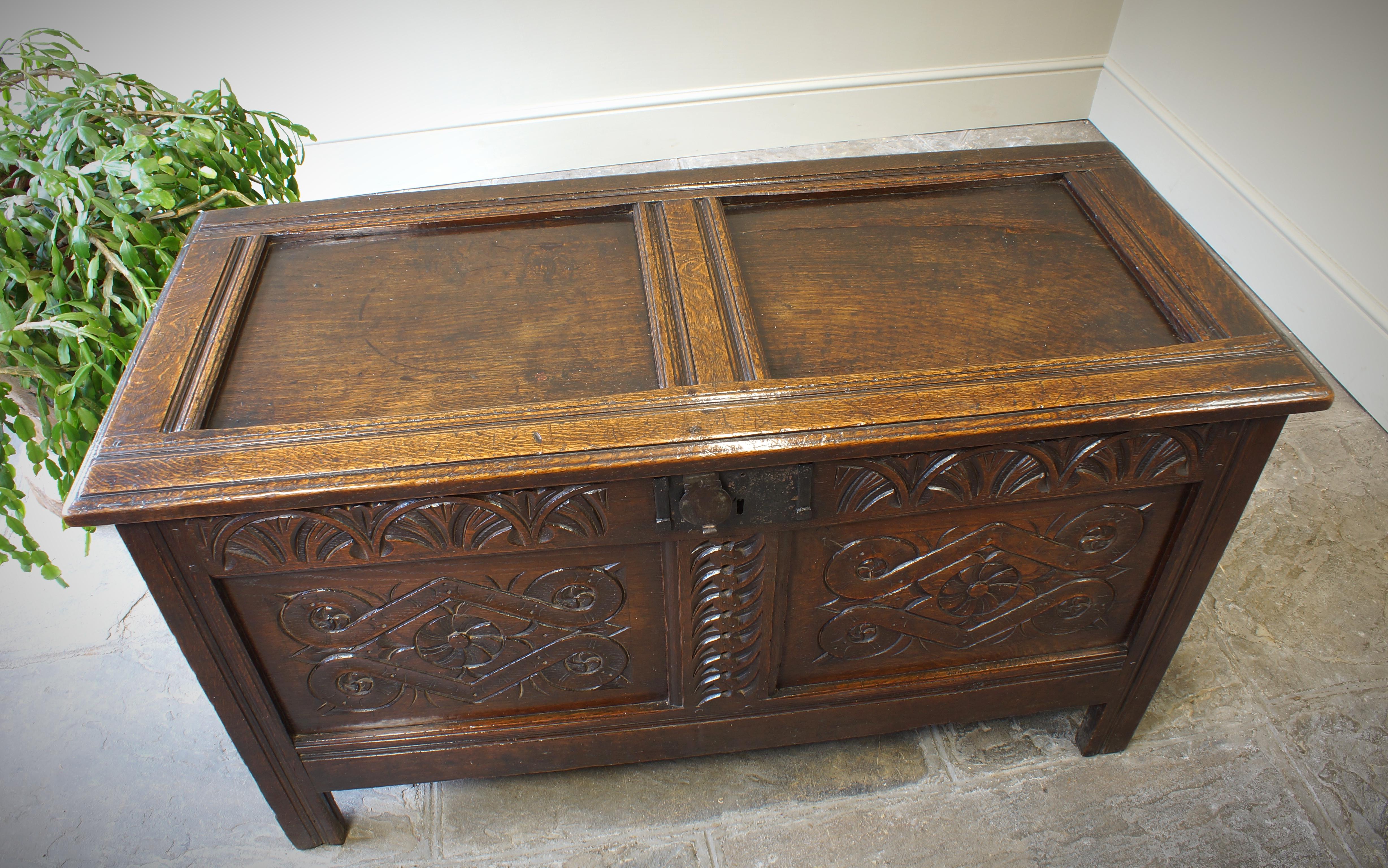 An excellent  17th Century Two Panelled Oak Coffer in good clean original condition, having good colour and patina. The panels are nicely carved with stylized lozenges and the top rail has crisply carved lunettes. Clean inside and with a wonderfully