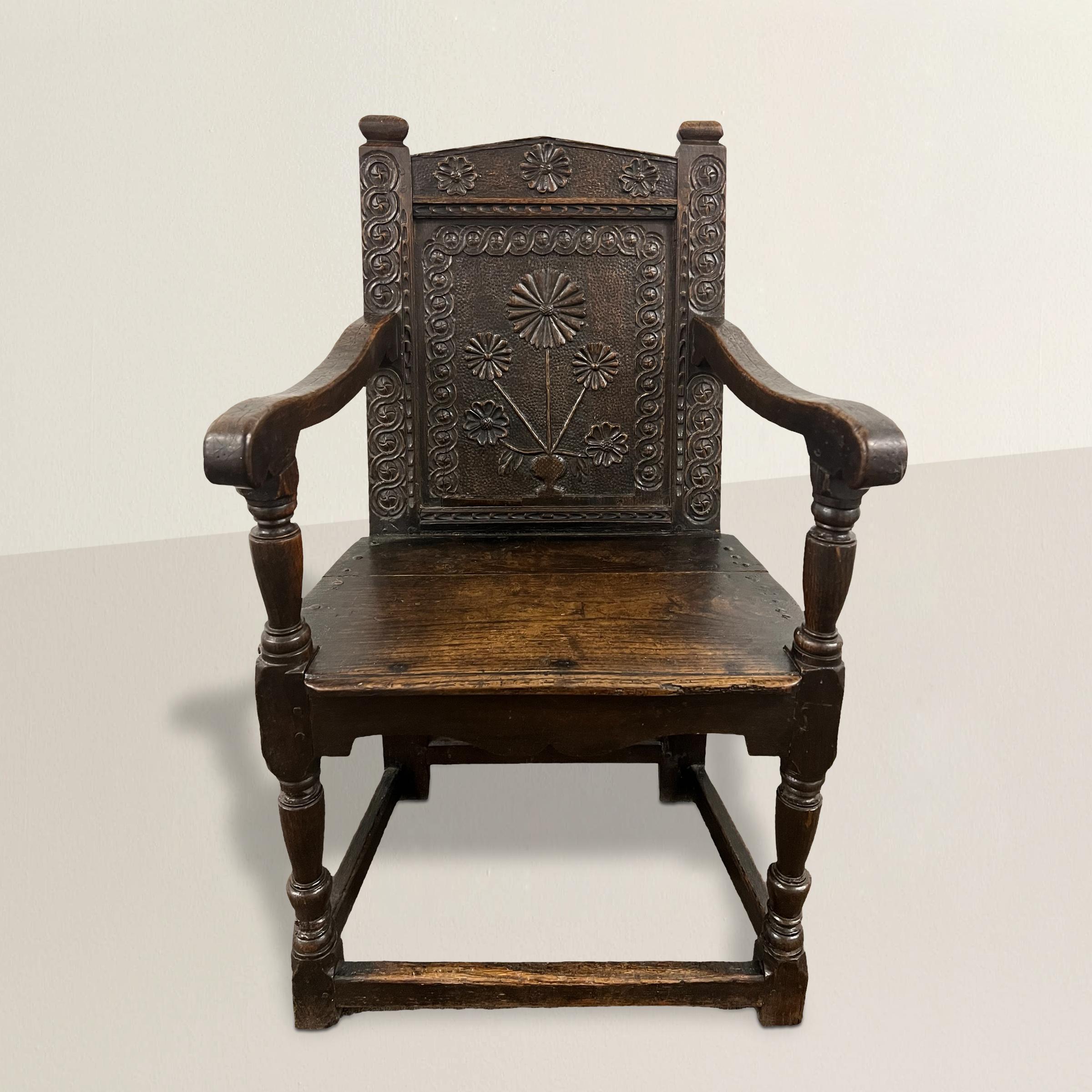 This exquisite 17th-century English oak Wainscot armchair stands as a testament to the era's masterful craftsmanship and artistic expression. The chair's standout feature, a carved daisy plant on the back splat, exemplifies the period's fascination