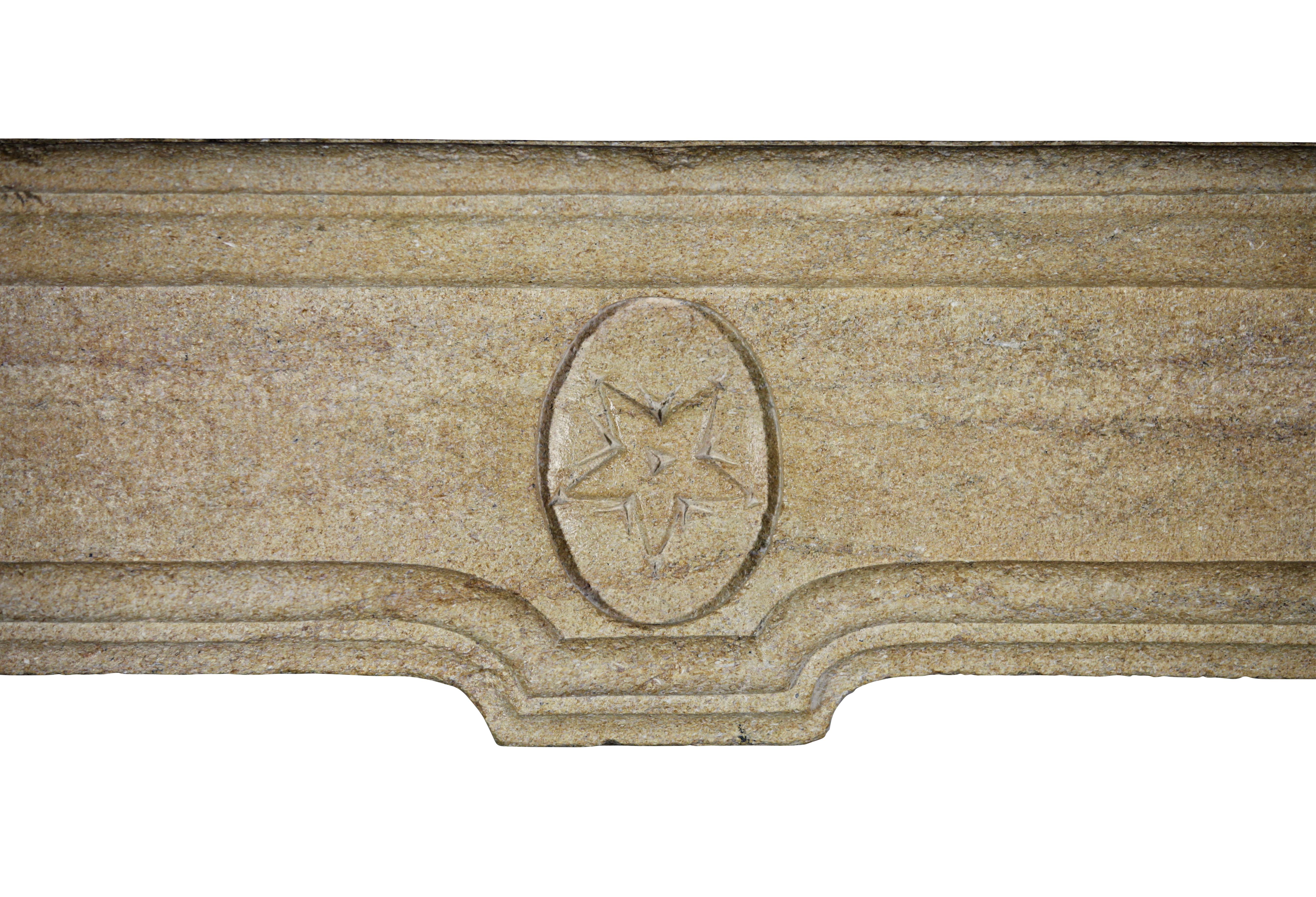 A very petite and unusual original 17th century limestone fireplace mantle with in the center a detail of a star. Perfect to fit a small and cosy room.

Measures:
107 cm EW 42.13