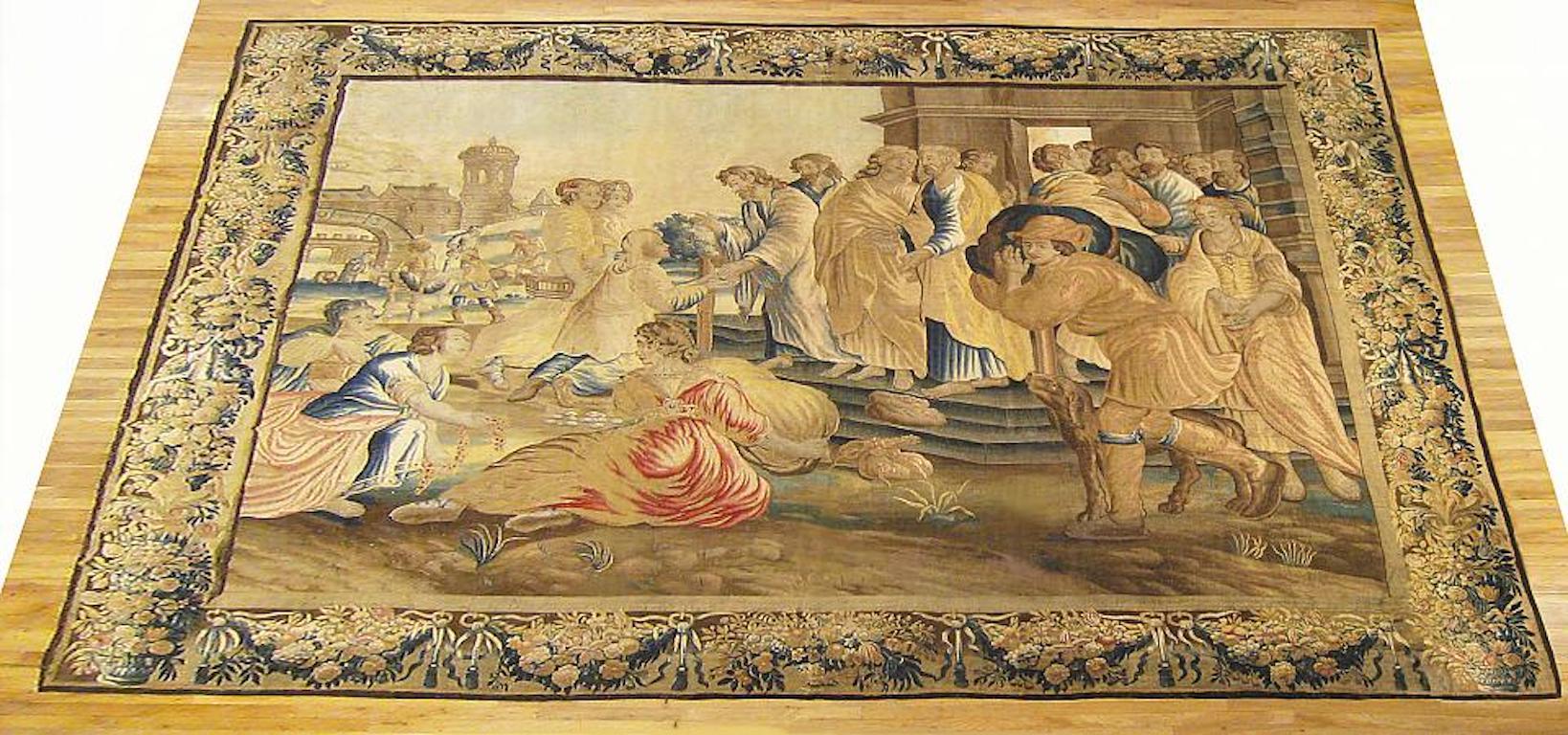 A Flemish allegorical tapestry from the first half of the 17th century, possibly mythological or biblical, envisioning a scene in which various figures seek guidance and help from a wise man that has arrived before them. Enclosed by an elaborate