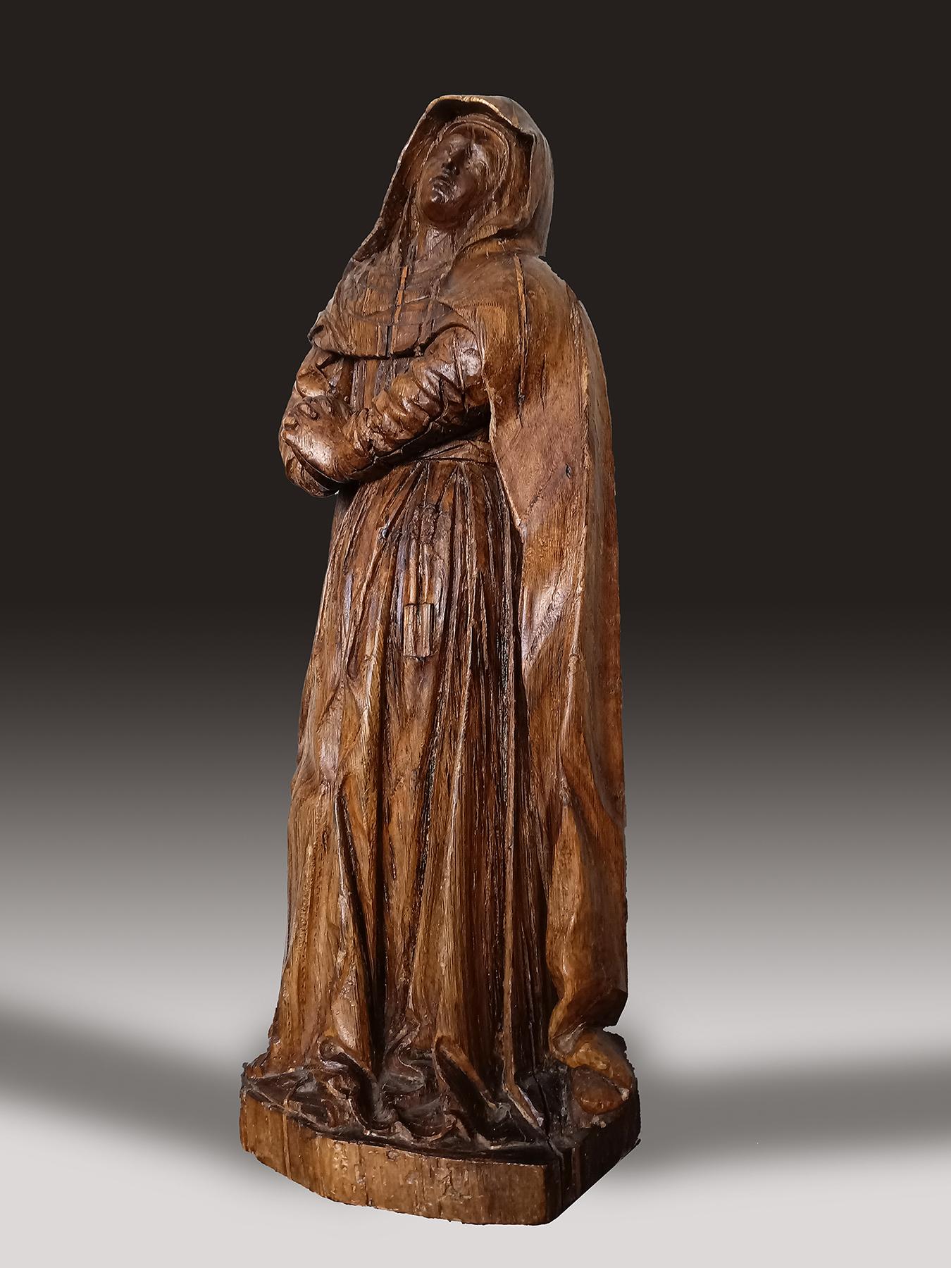 The Mourning Virgin
Probably South Netherlands, early 17th century
Oak; approximate size: 36.5 cm (h)

A 17th century oak figure of the Mourning Virgin carved in-the-round with an integral octagonal base. This figure probably once flanked the