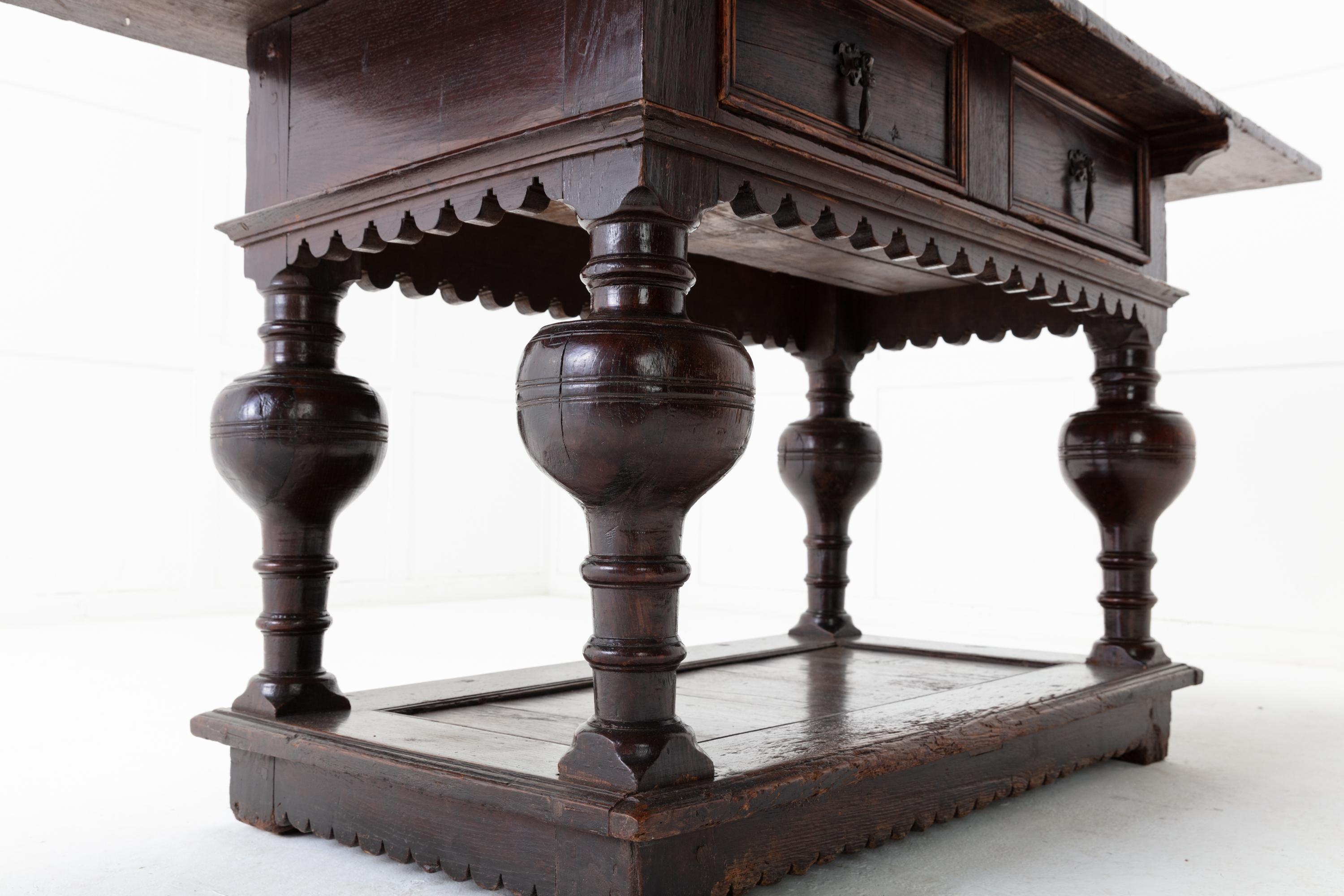 17th Century Flemish oak side table with two drawers. Excellent original condition and colour. Having an oversized top over two drawers with a decorative frieze. Standing on four oversized bulbous legs. Terminating on to a decorative carved platform