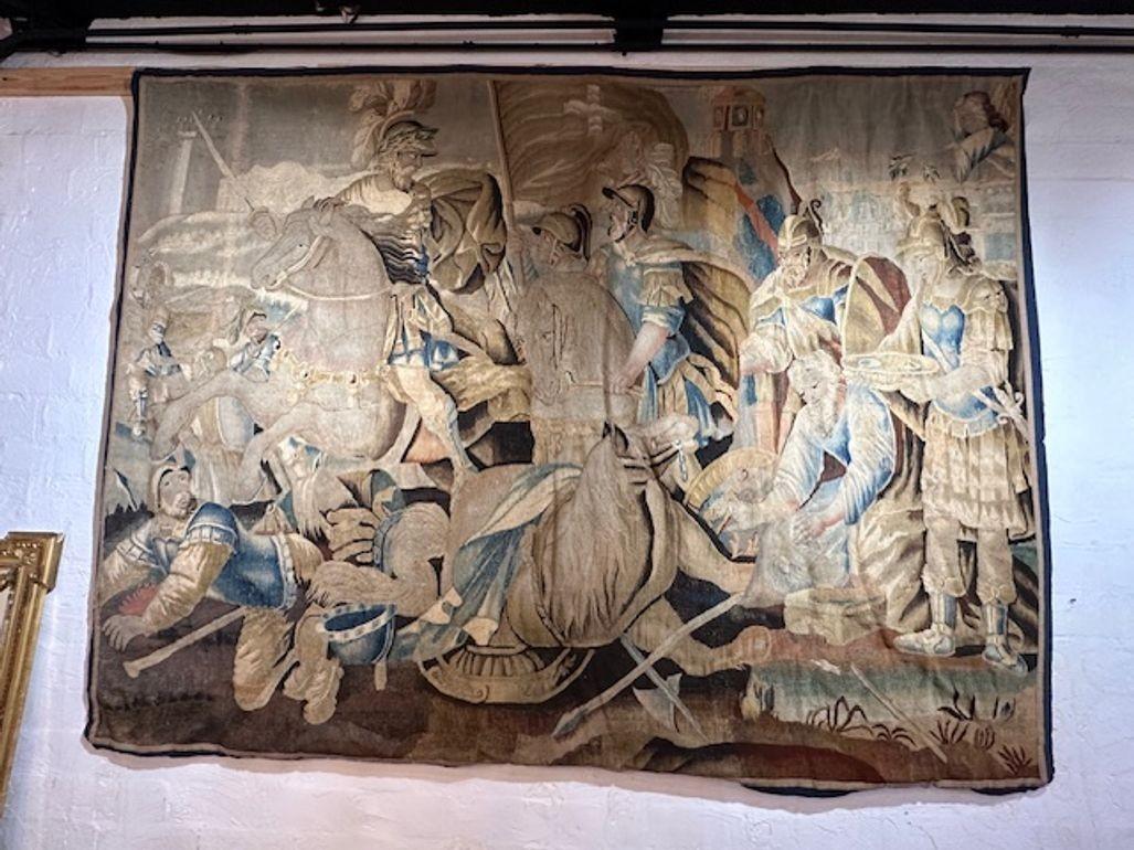 Exceptional Flemish tapestry featuring beautiful muted colors and a theme of soldiers and horses. A stunning work of art.