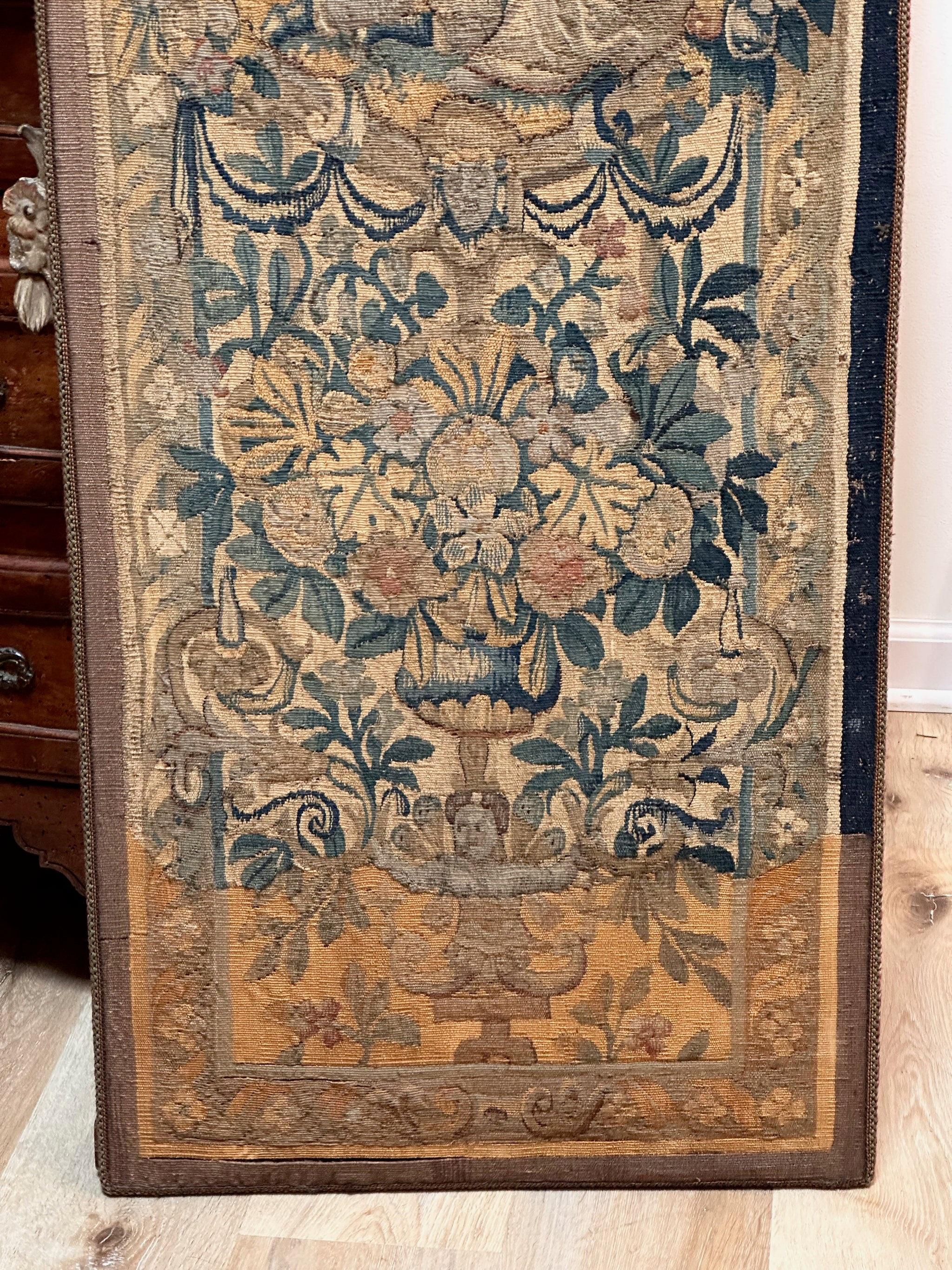 Mounted 17th Century Flemish tapestry panel having finely woven foliate designs with cherubs, a maiden, a landscape over a vase of flowers.  Fine detail and lovely color.
