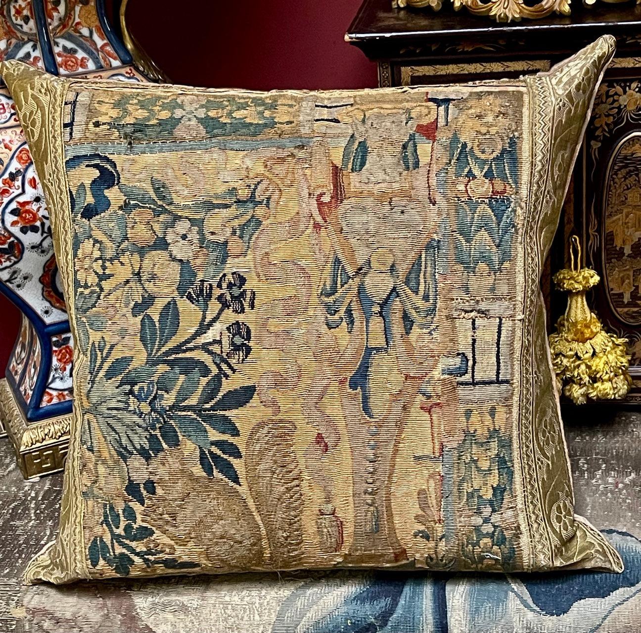 A bespoke hand made pillow Incorporating early textiles

17th Century Flemish (Brussels) Tapestry Panel Woven in naturally dyed wools and silks

Finished with 18th century metallic braid. The gold Pomegranate brocaded fabric backing is later

Lovely