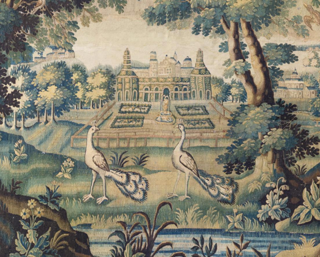 This is a gorgeous antique 17th century Flemish Verdure landscape tapestry depicting a beautiful and rich summer scene of a countryside with lush trees and vegetation, and two peacocks with ornate gardens and a grand estate in the distance. The