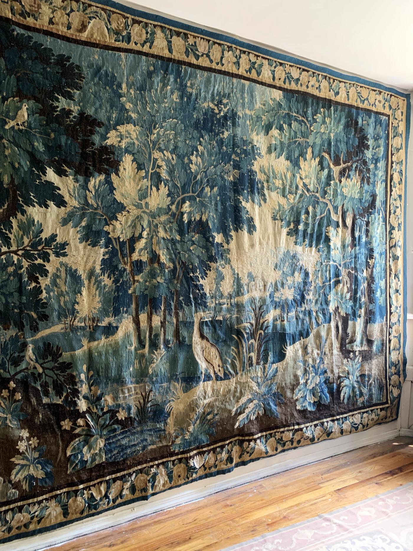 A magnificent verdure tapestry in the Louis XIV style with deep coloring of blues and greens. Decorated with birds and rich foliage, this tapestry is a landscape of fine quality and rare preservation.