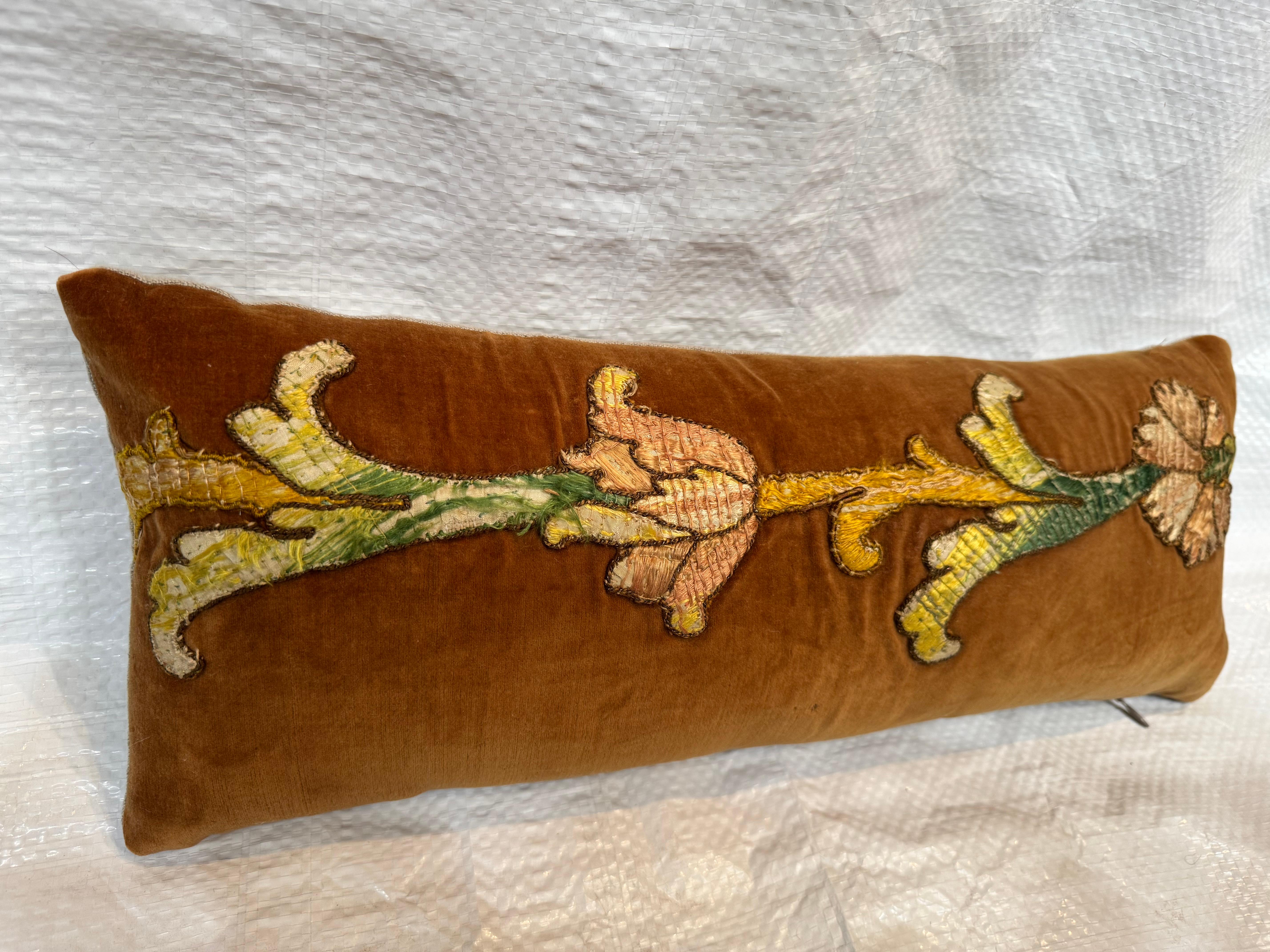 An opulent fragment of 17th-century Florentine textile art, this piece showcases masterful craftsmanship in deep crimson cut velvet over a shimmering silk ground. The richly textured surface features scrolling vines and stylized floral motifs