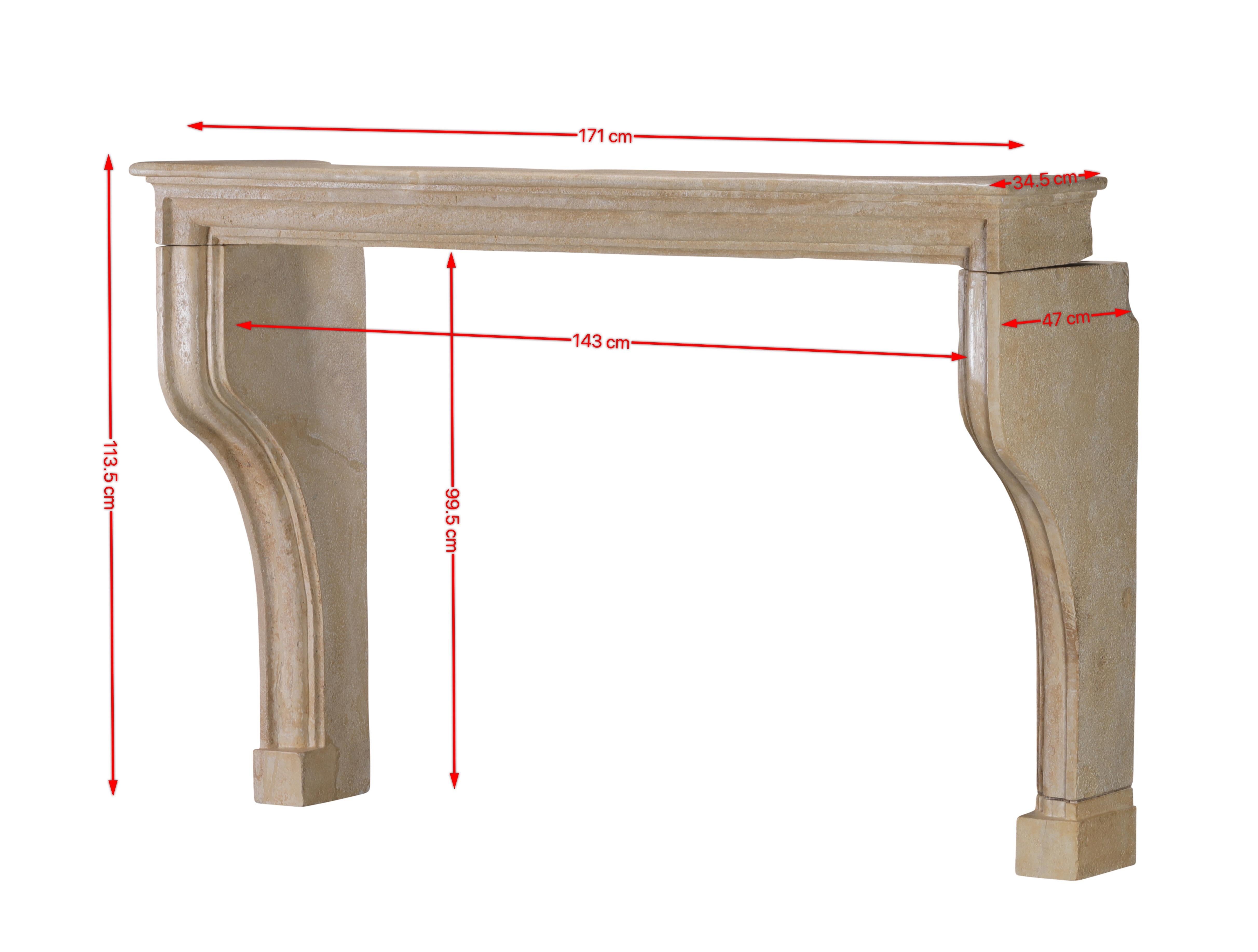 This exceptional 17th-century French fireplace surround is crafted from a warm, honey-beige limestone that is gently aged with natural patina, exuding a subtle rustic sophistication. Its hand-carved contours and graceful curved jambs reflect the
