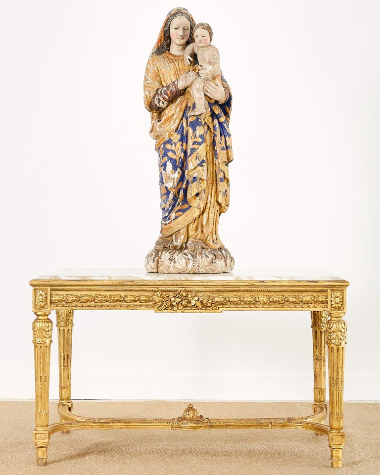Extraordinary polychromed 17th century French baroque Madonna and Child sculpture. Large carved statue carved from a single column of wood which was hollowed out in the back for weight and to reduce cracking in the wood. Gracefully flowing robes