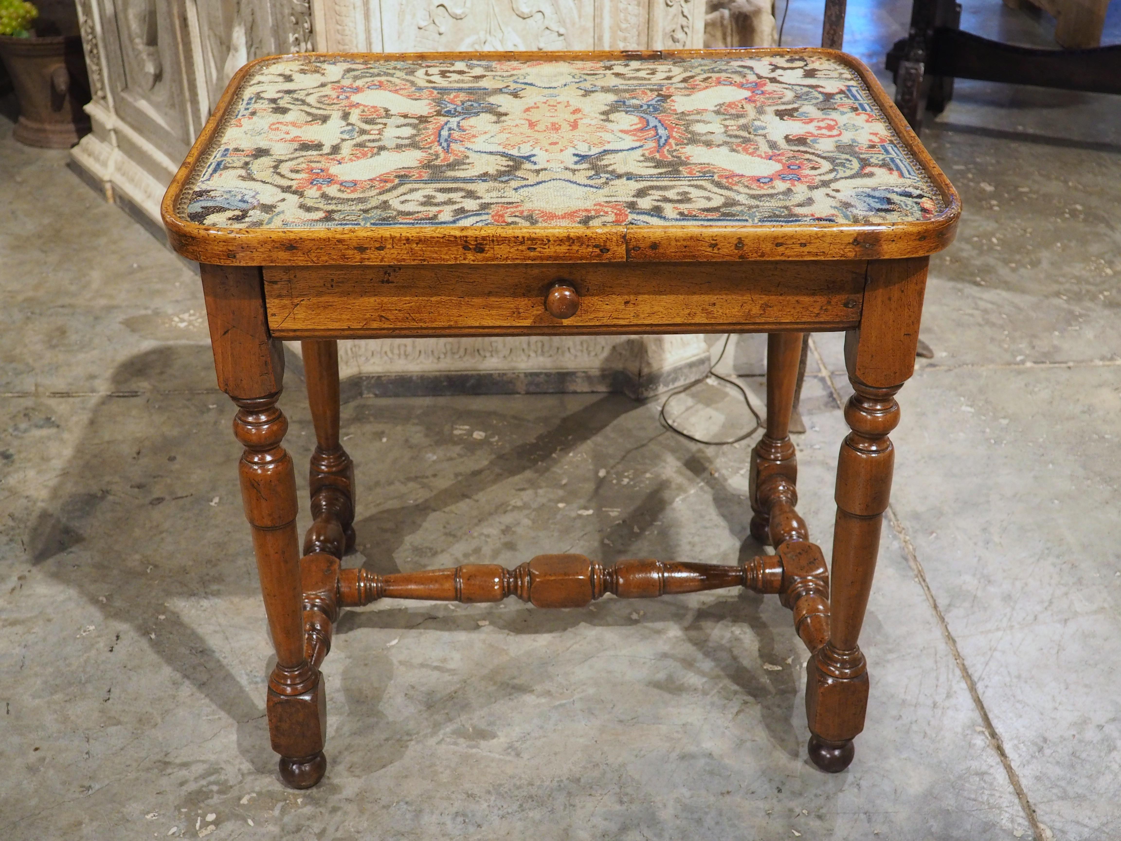More information coming soon…

Hand-carved in walnut during the 1600s, this amazing side table is from Burgundy, France.  The original top has been replaced with a swath of needlework, dating to the 1800s.  The original walnut has a rich, brown