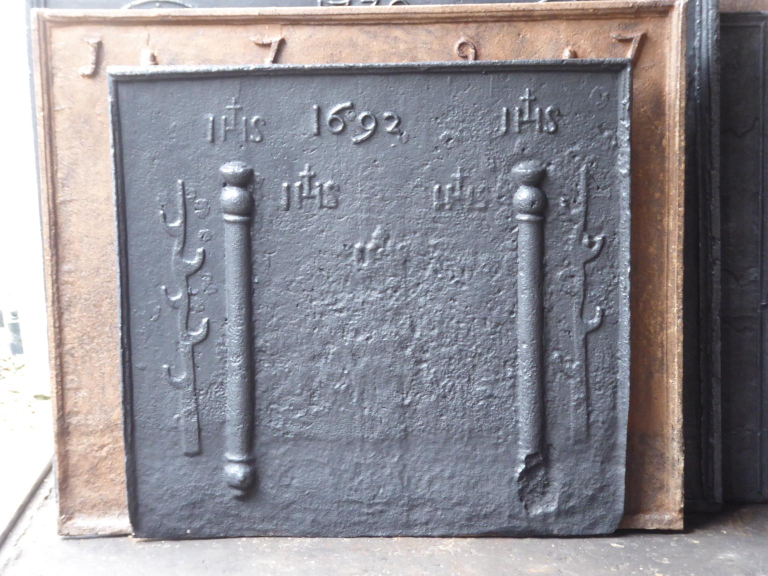 17th century Louis XIV French fireback with pillars, three IHS monograms, and the date of production 1692.

The monograms IHS stand for Iesus Hominum Salvator (Jesus the Savior of Humanity) or In Hoc Signo (In this sign will you win). The pillars
