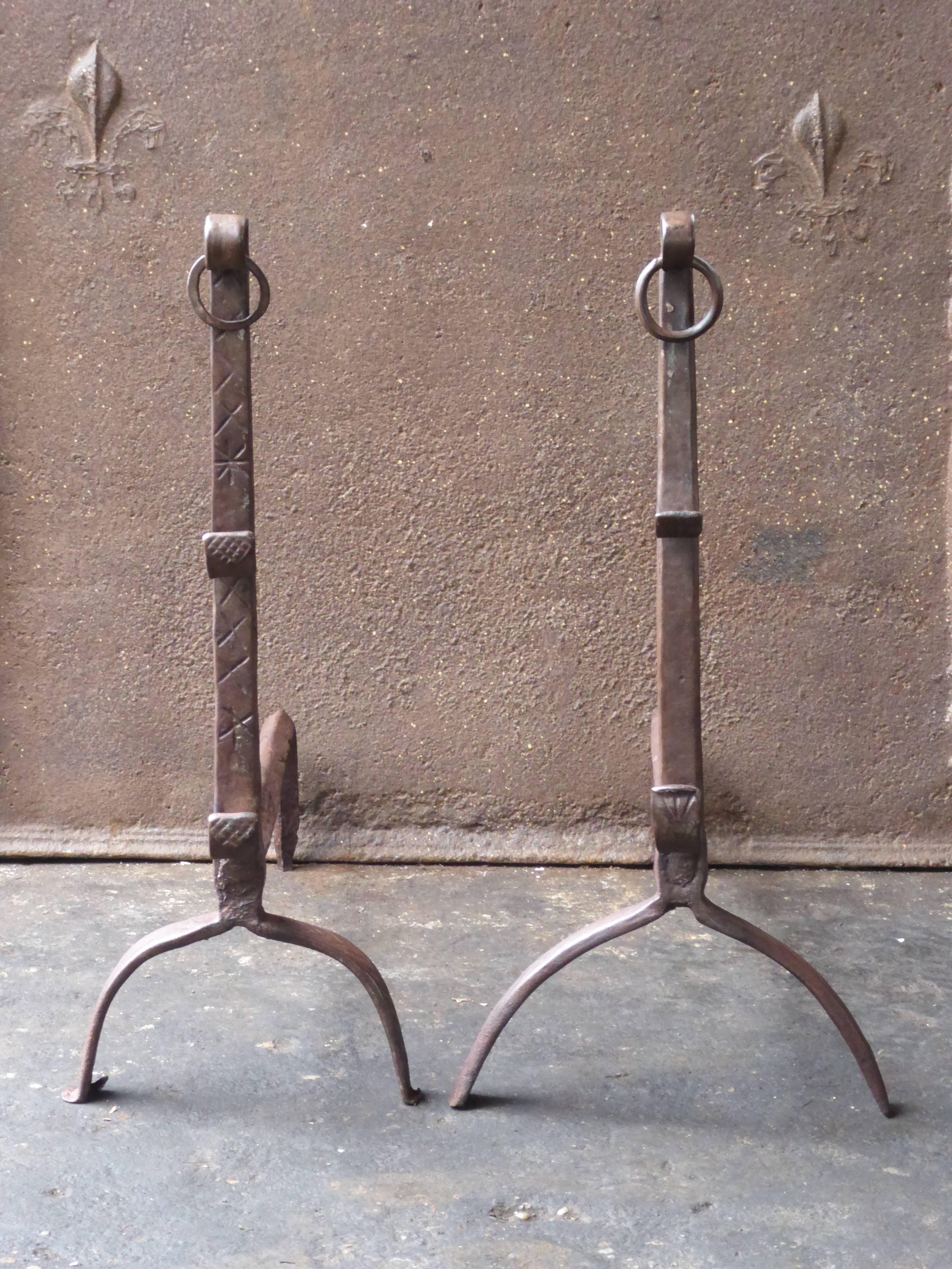 17th century French Gothic andirons made of wrought iron. The andirons are in a good condition and are fit for use in the fireplace.

