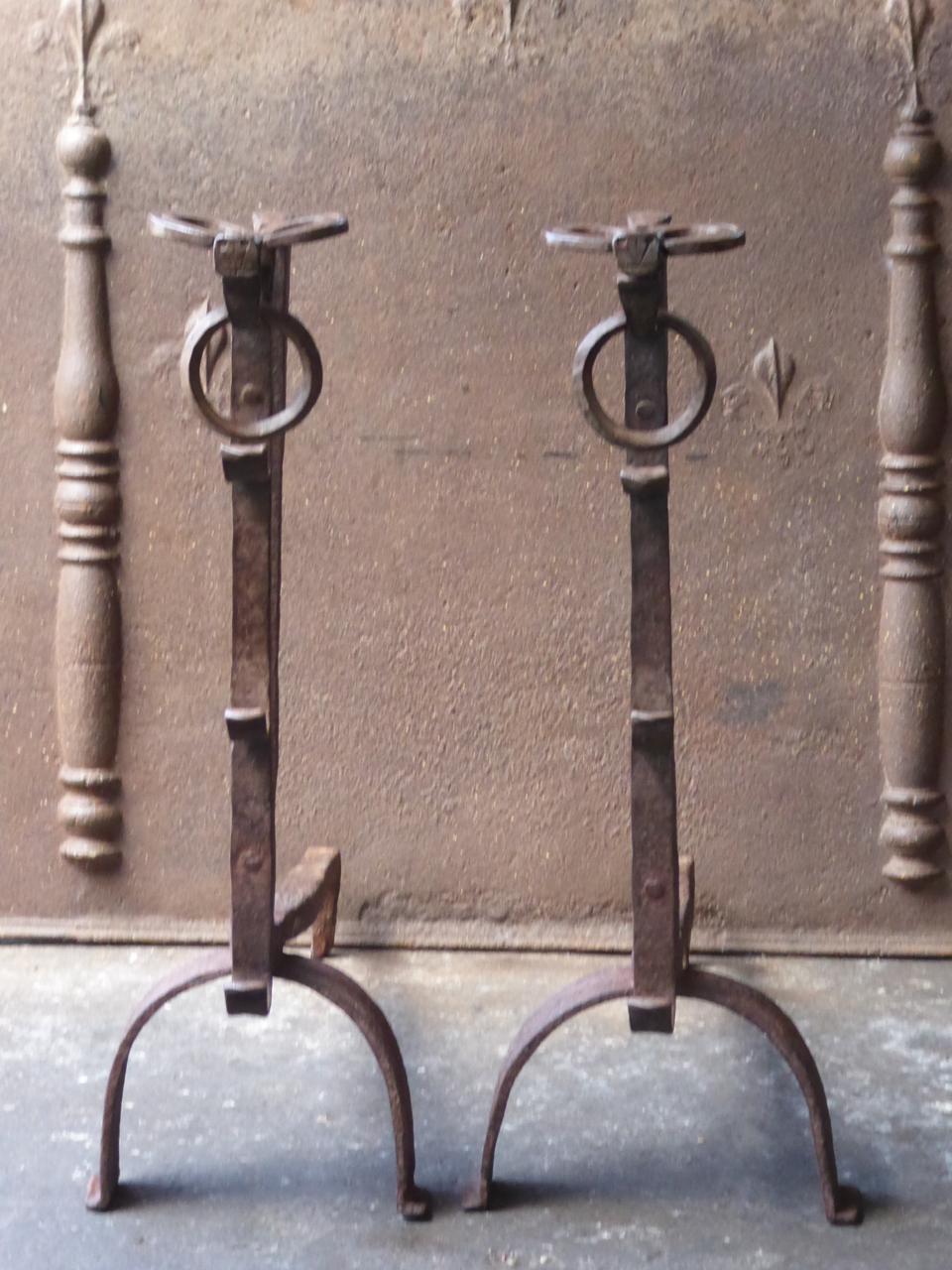 Magnificent pair of 17th century French Gothic andirons made of wrought iron. The tops of the andirons consist of bulls heads, which is characteristic for this type of andirons. The andirons are also called 'landiers' in France. 







 