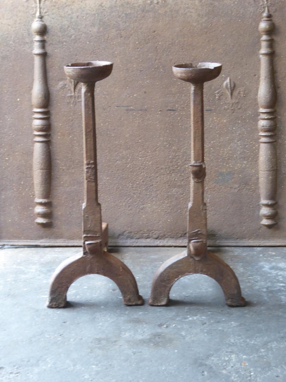 17th century French Gothic andirons made of cast iron. The andirons have spit hooks to grill food and cups to warm drinks. In France this type of very old andirons are called 'landiers'.

This product weighs more than 65 kg / 143 lbs. All our