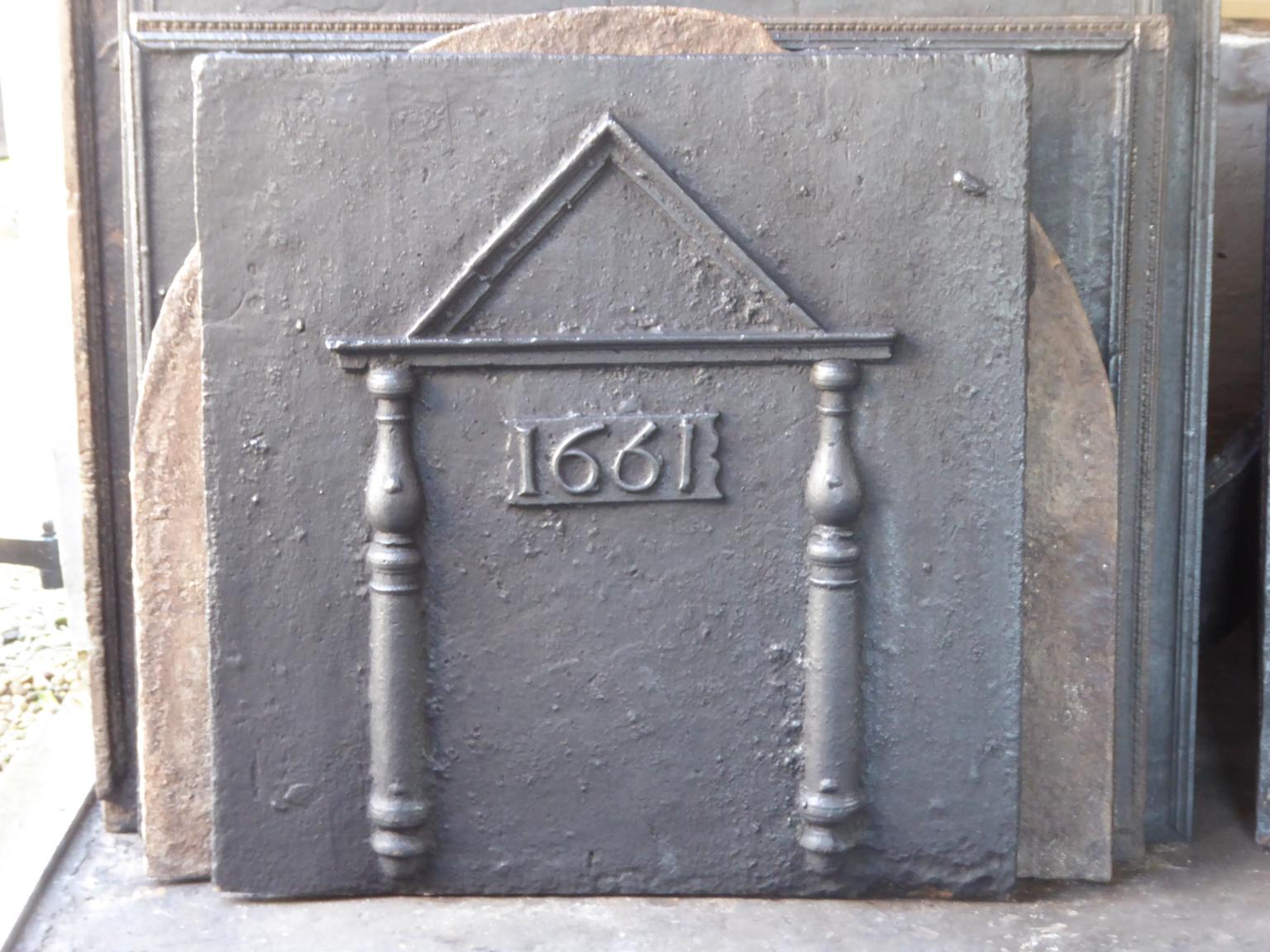 Heavy French gothic fireback with pillars and a pediment . The two pillars of Hercules stand for strength and the unknown. The pediment was a classical architectural element to add grandness. The date of production, 1661, is also cast in the