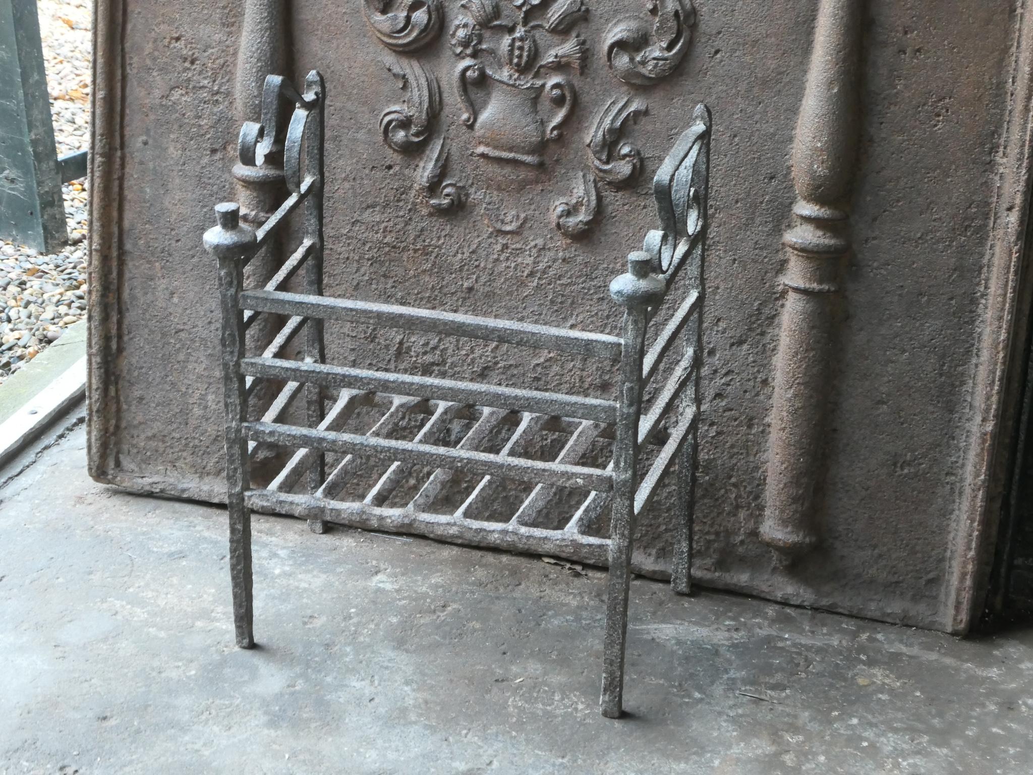 Beautiful 17th century French Gothic fireplace grate. The grate is made of wrought iron. It is in a good condition and fully functional.