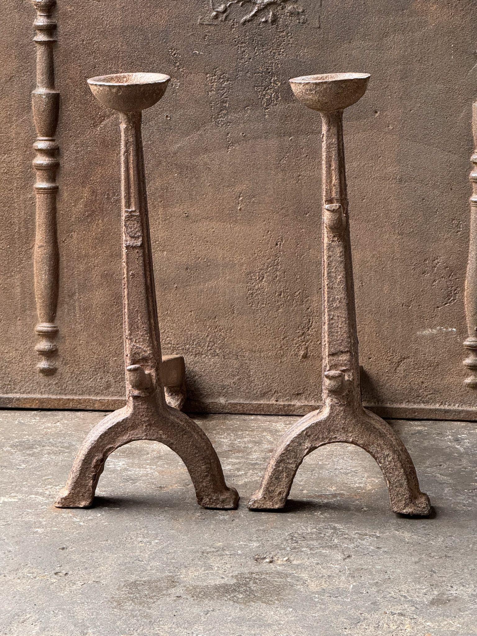 17th Century French Gothic Period Firedogs or Andirons. Made of cast iron. The andirons are in good condition and are fully functional. 

With spit hooks to grill food and a cup to keep drinks or soup warm.