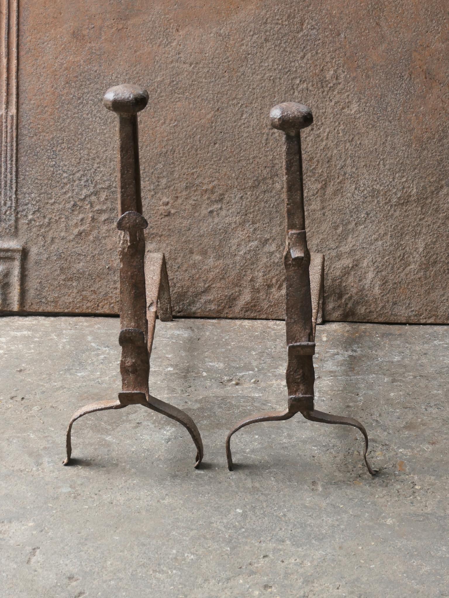 Large 17th century French Gothic Period andirons. The andirons are made of wrought iron. They have spit hooks to grill food. The condition is good.