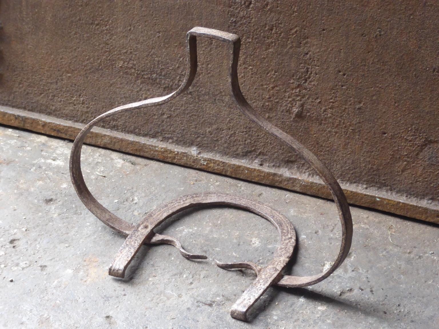 17th century French hanging trivet made of wrought iron. The hanging trivet was used for cooking in the fireplace, to put a pot into. It was used in combination with a trammel and/or a chain. It is still fully functional.







 