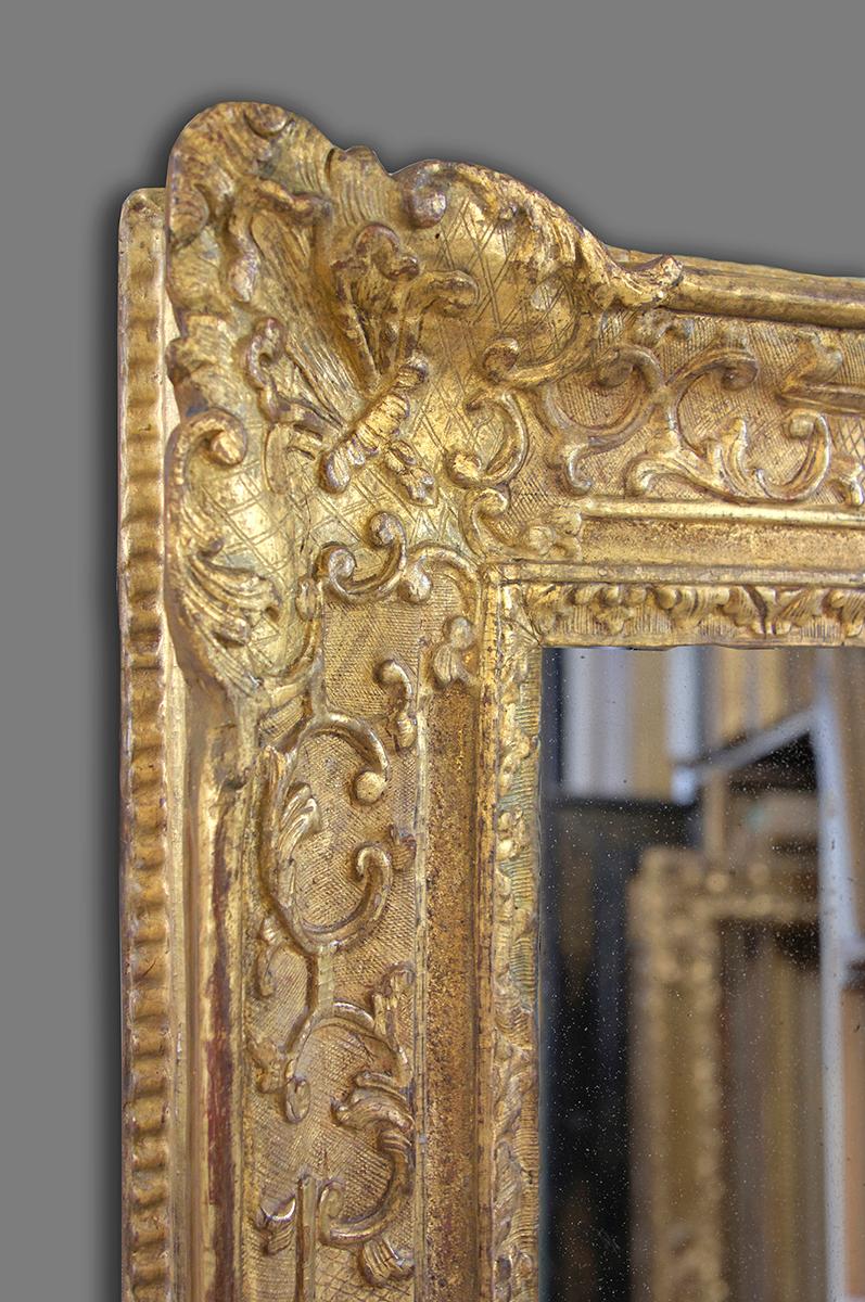 This is with out doubt an exceptional hand carved 4th quarter 17th century late Louis XIV- early Régence frame. It has an ogee - frieze profile with the following ornament carve in oak: corner, centre and demi-centre cartouches with fanned