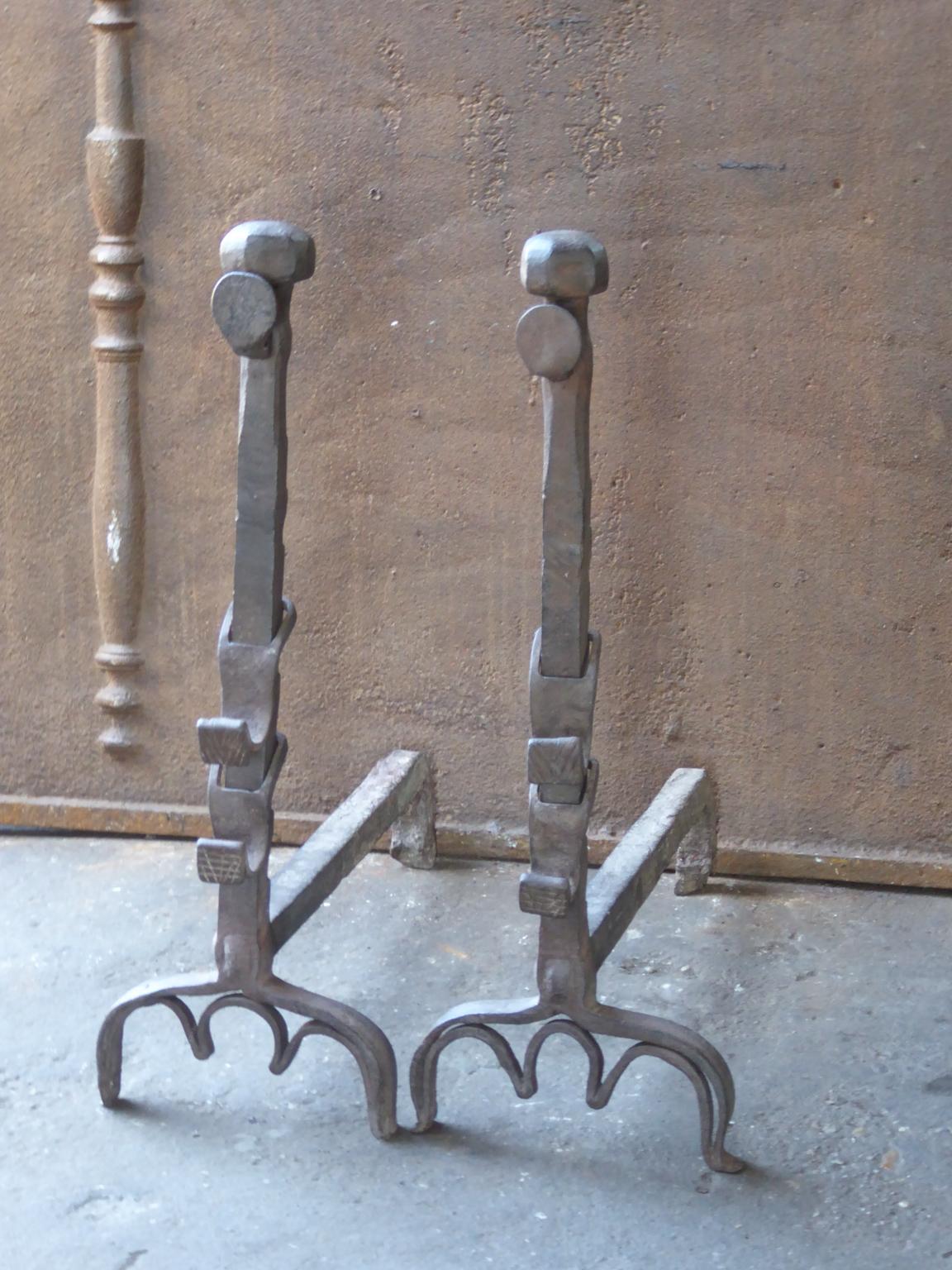 17th century French andirons made of wrought iron. The style of the andirons is Louis XIII and they are from that period. They have a natural brown patina, which can be made black / pewter upon request. The andirons have spit hooks to grill food.