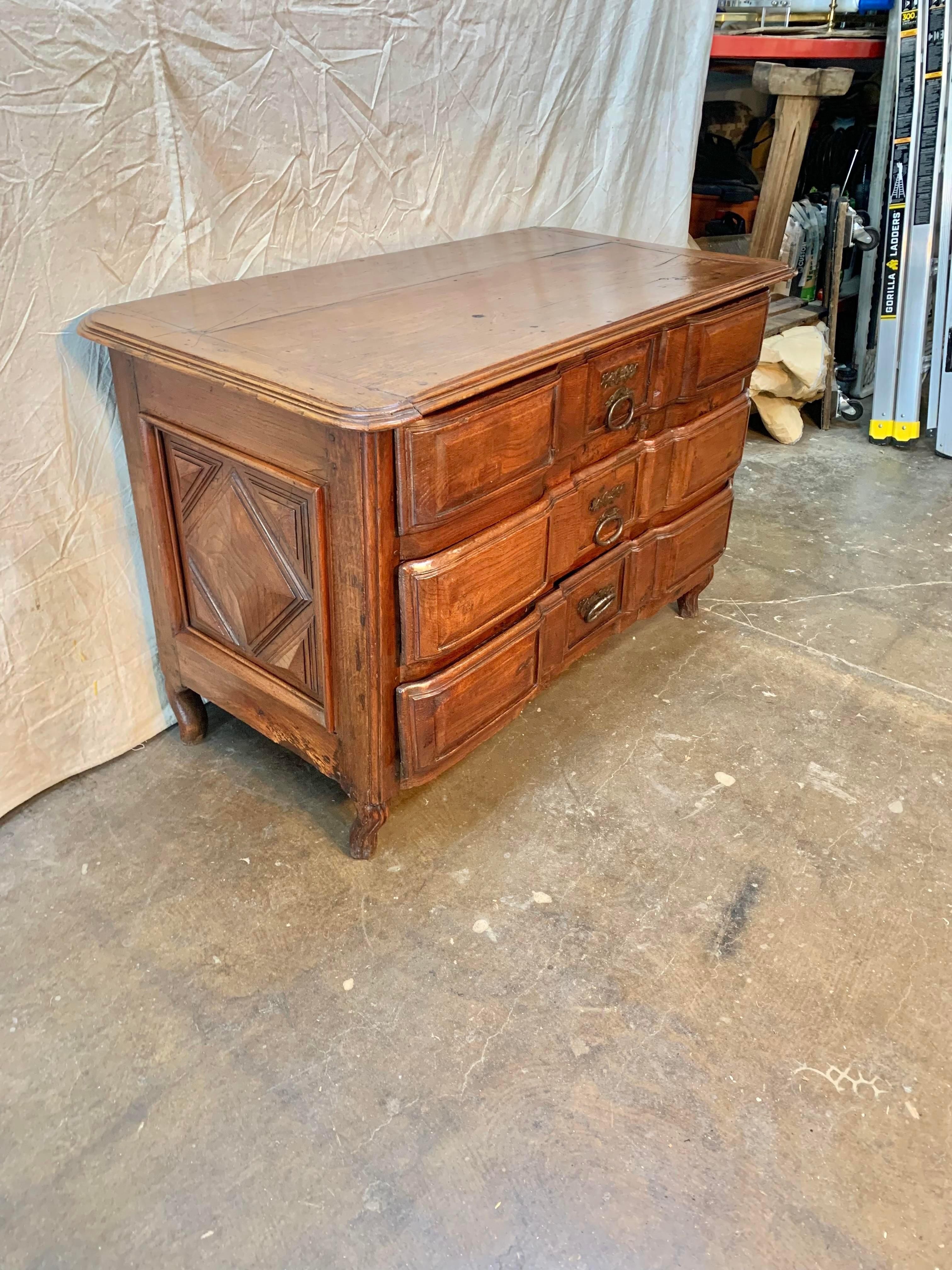 This exceptional 17th century French Louis XIII commode was handcrafted from solid old growth French oak by talented rural artisans in Normandy that were skilled in the ways of woodworking, yet using more rudimentary hand tools than were available