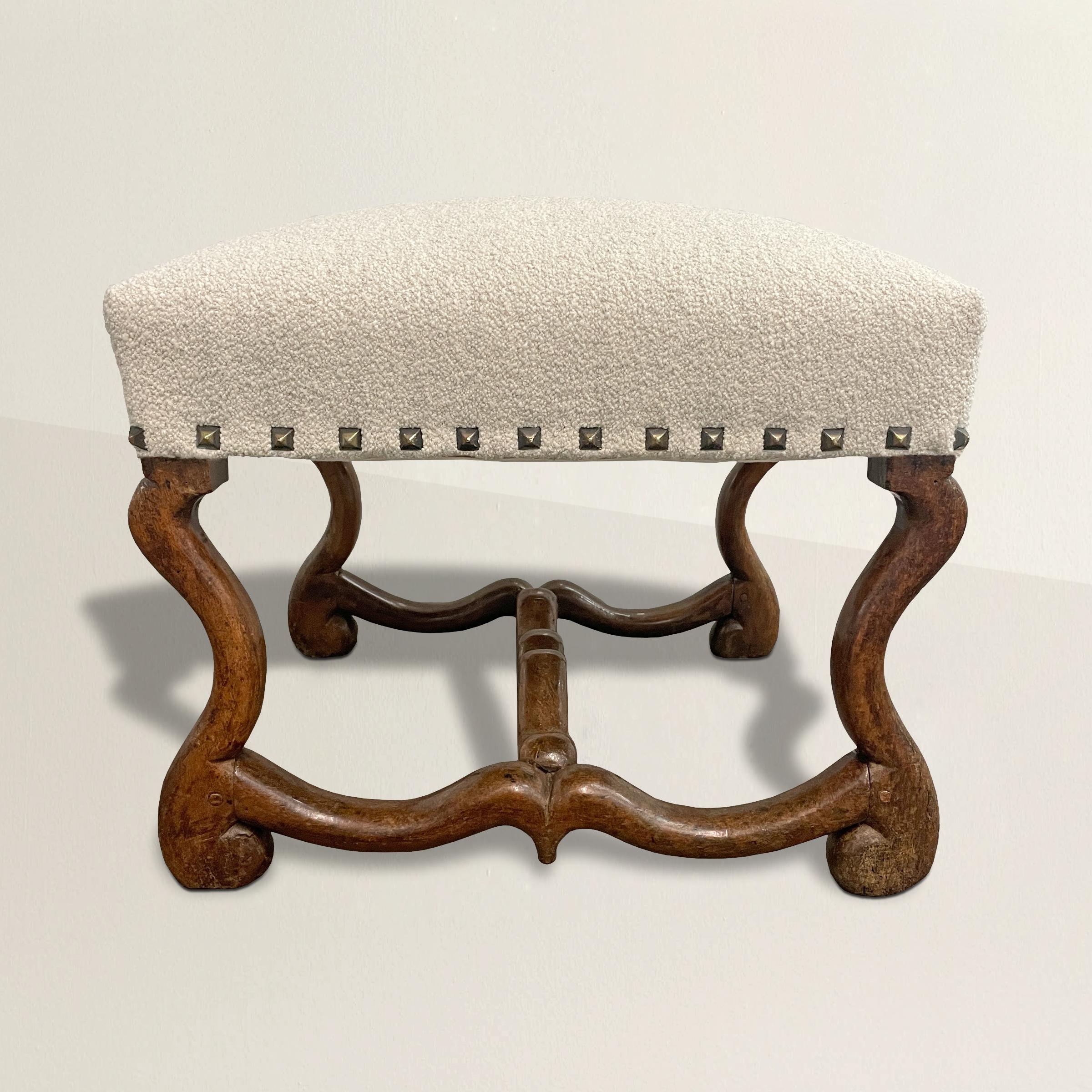 A wonderful 17th century French Louis XIII walnut os-de-mouton (sheep's bone) ottoman newly upholstered in a wool Italian bouclé and square pointed nail-head trim. Perfect as an ottoman at your favorite armchair, for extra seating in your living