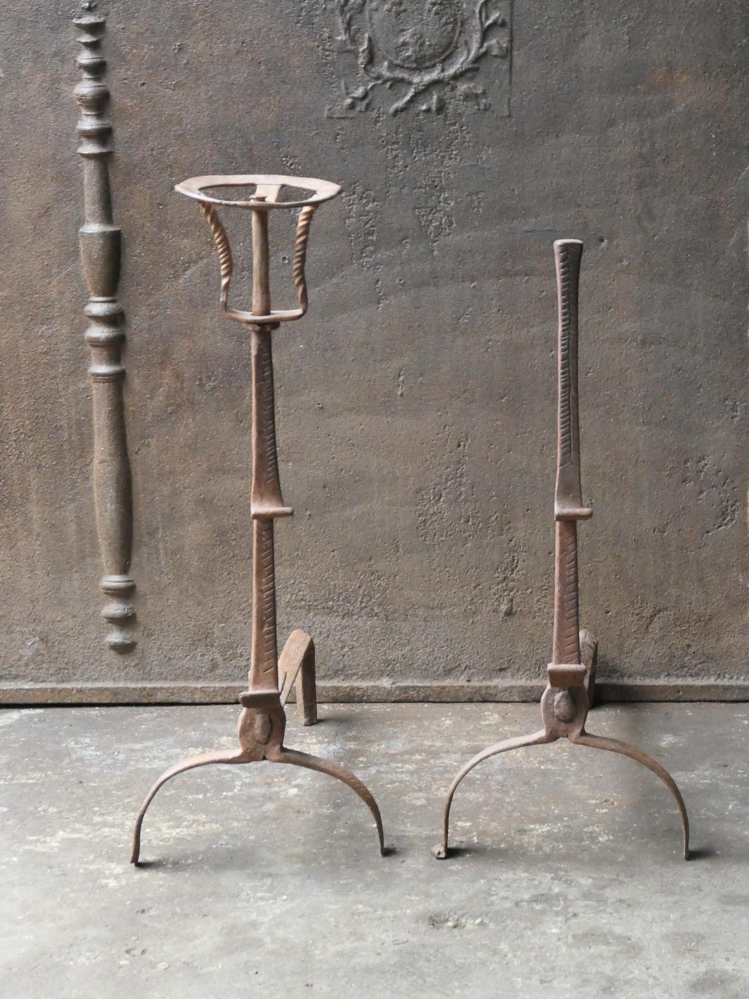 17th century French Louis XIII period fire dogs with spit hooks. Made of wrought iron. These French andirons are called 'landiers' in France. This dates from the times the andirons were the main cooking equipment in the house. They had spit hooks to