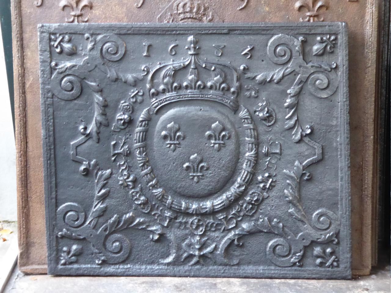 17th century French Louis XIV fireback with the arms of France. These are the arms of the house of Bourbon which supplied kings for France and for Spain. The three Fleurs de Lys (French Lilies) symbolize the purity of nobility. The crown stands for