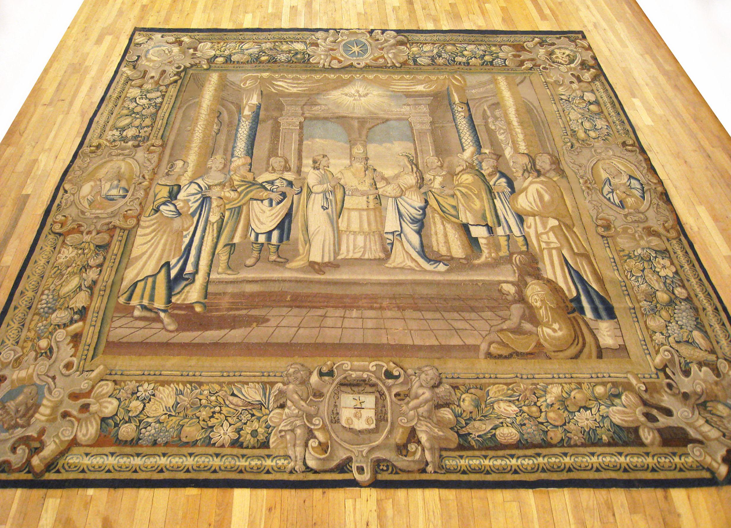 A French religious tapestry from Paris, circa 17th century, size 11' H x 11' W. This magnificent handwoven wool and silk wall hanging envisions the marriage of the New Testament figures, Mary and Joseph, with the High Priest flanked by Mary and