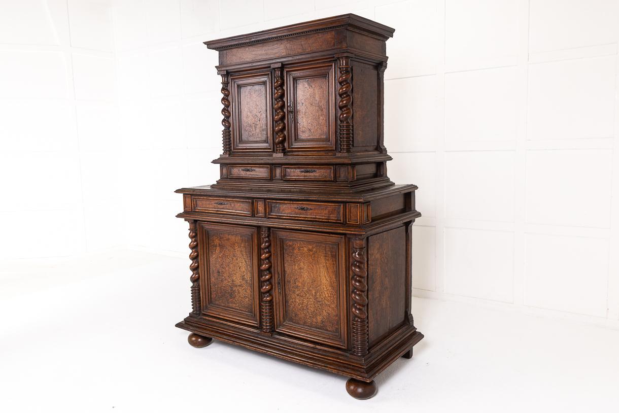 A very rare, and excellent example a 17th Century Renaissance period two-body (buffet deux corps) cabinet constructed in oak and pollard oak, richly moulded and carved throughout. The upper part, with a dentil moulding cornice, is set back. Two