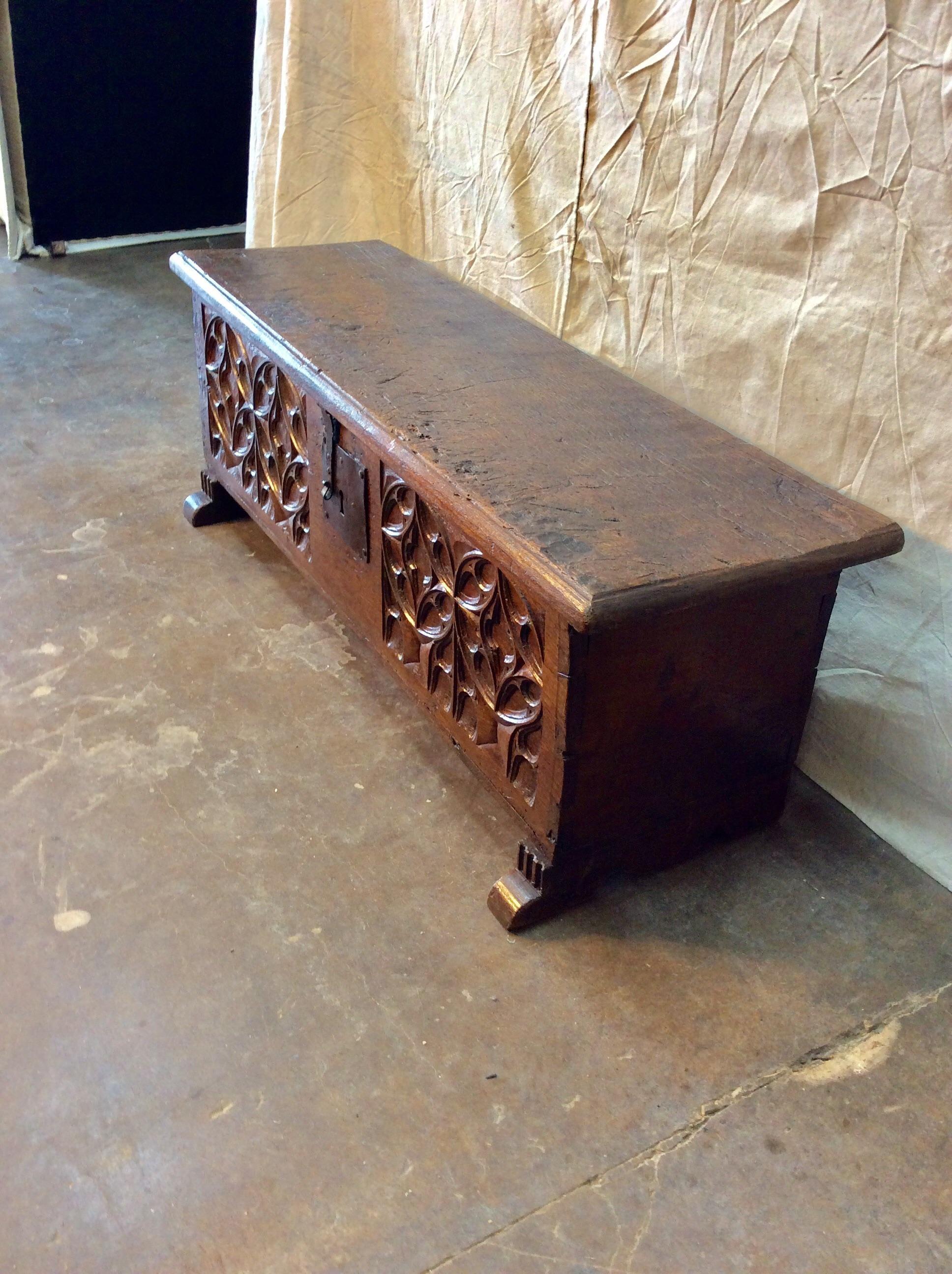 Found at the Paris Flea Market this 17th Century French Oak Trunk features hand carved and original hand forged iron hardware. The piece has a thick and solid top which lifts to reveal iron straps and wonderful storage. Four hand carved quatrefoils