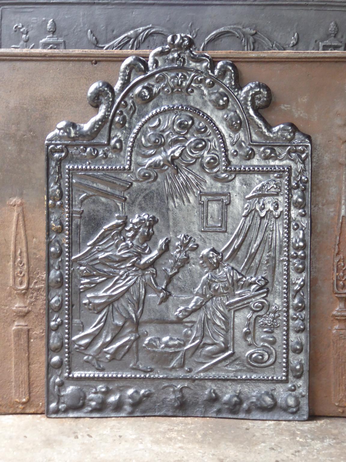 Beautiful, 17th century, French fireback with the annunciation to Mary. The style of the fireback is Renaissance and it is from that period. 

The fireback is made of cast iron and has a black / pewter patina. The condition is good, no cracks.