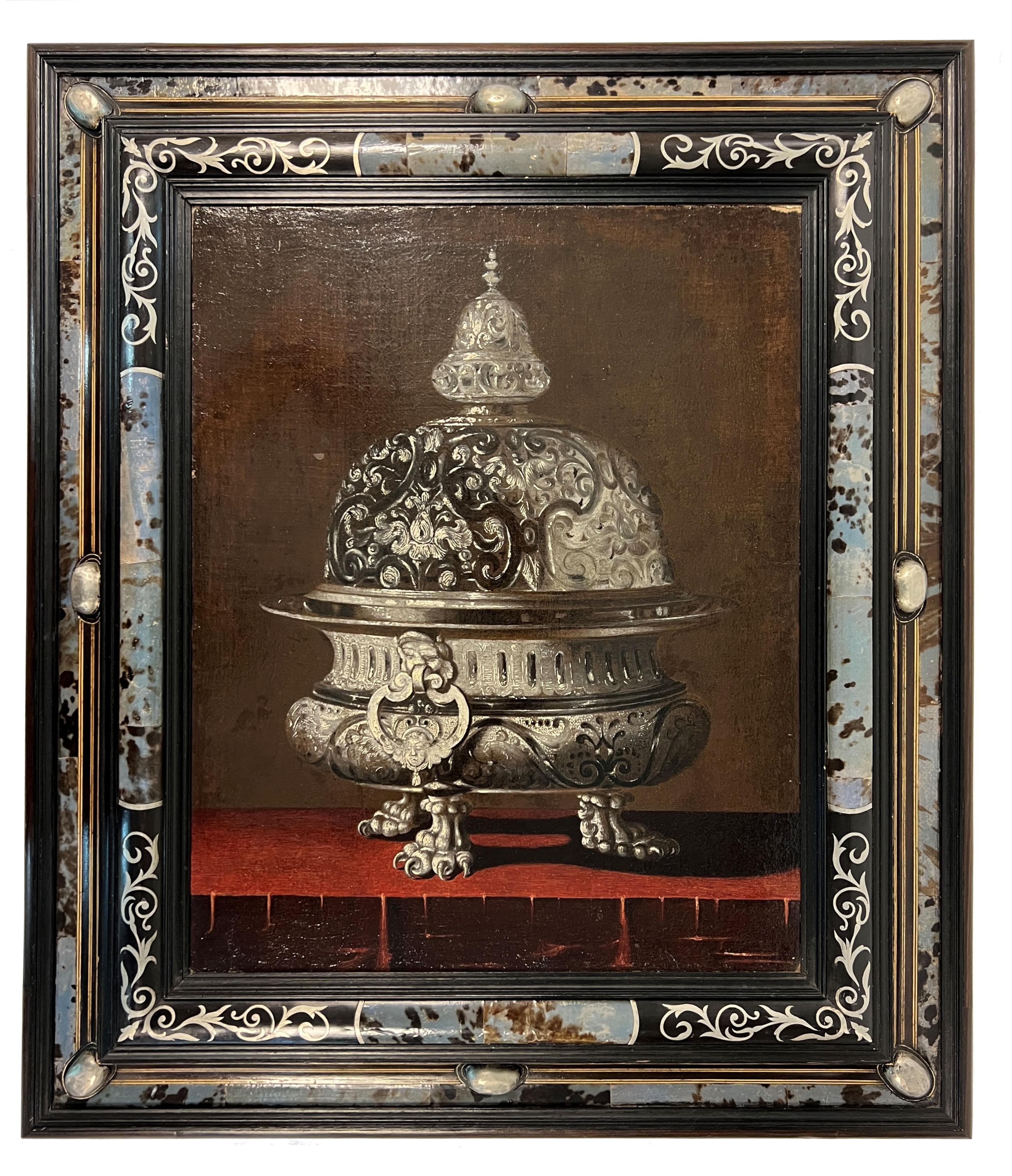 Our still life depicting a metal brazier on ledge is a rare painting by Baudouin Yvart (French, 1611-1690).  Stretcher measures 15 1/4 by 19 inches. 

It has an extraordinary ebonized sgraffito frame, 24 by 28 by 1 3/4 inches, with inlaid mother of