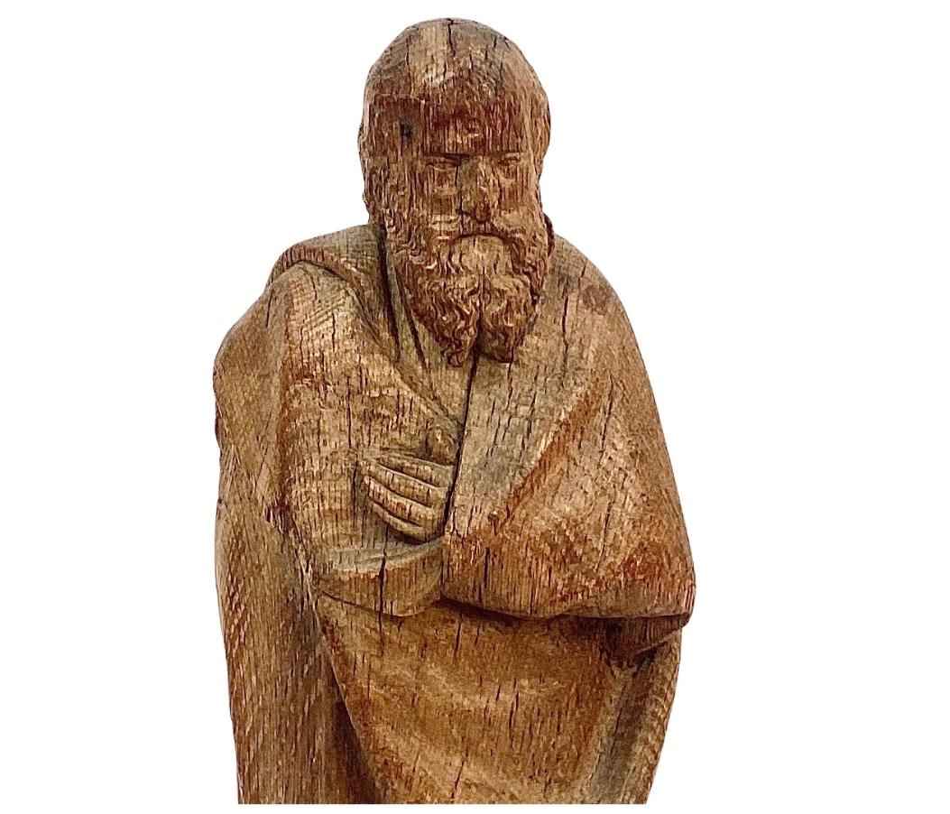 17th Century German hand-carved oak religious sculpture. Possibly a saint or a bishop. The bearded man is cloaked in draped fabric with only left hand peeking out near chest. 