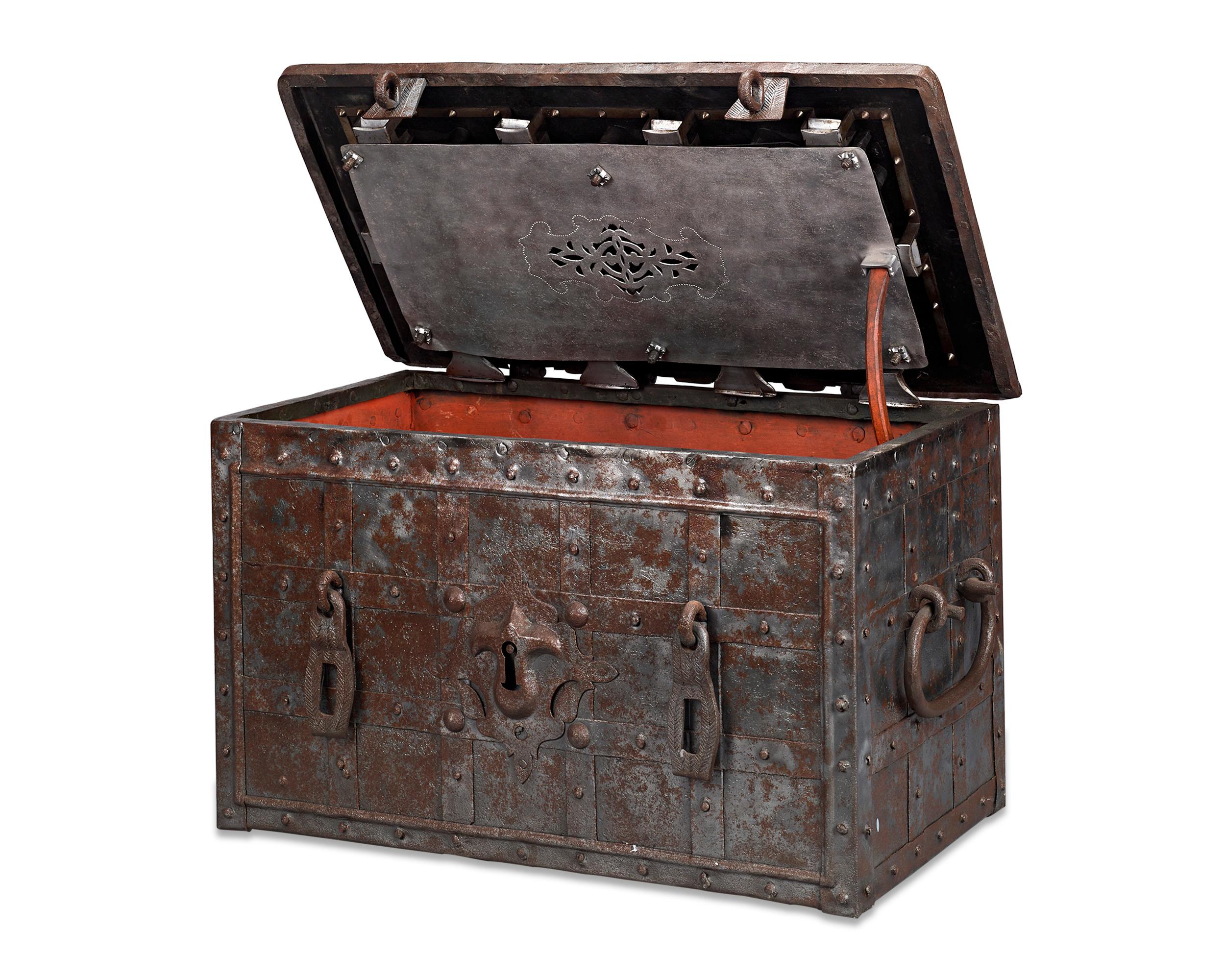 This rare German Baroque Renaissance strongbox is crafted of reinforced wrought iron and is designed to be impenetrable. Intended to secure one's most precious valuables, the strongbox, also known as an 