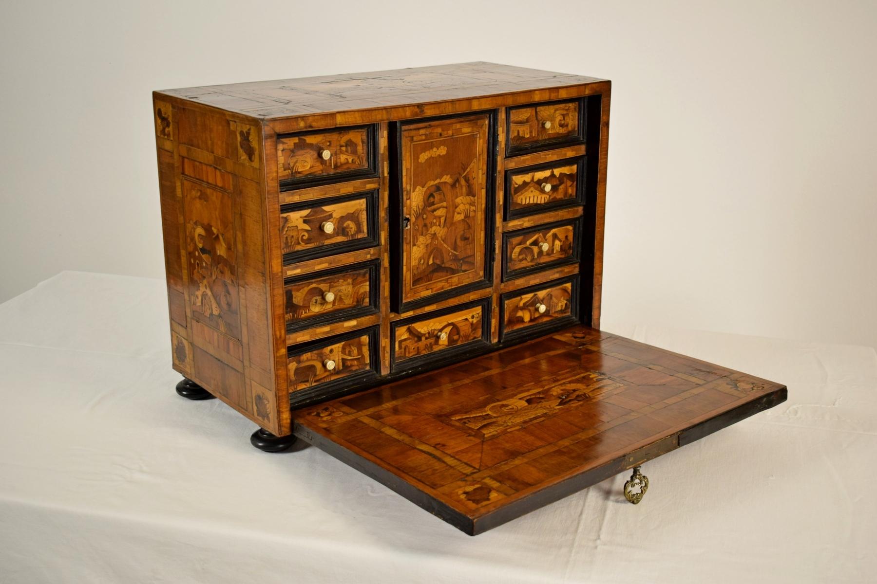 17th century, German wood apothecary cabinet with fantasy architectures

This small apothecary cabinet was made in the 17th century in Germany, in wood finely decorated with inlays depicting architectural patterns of fantasy, obtained with the