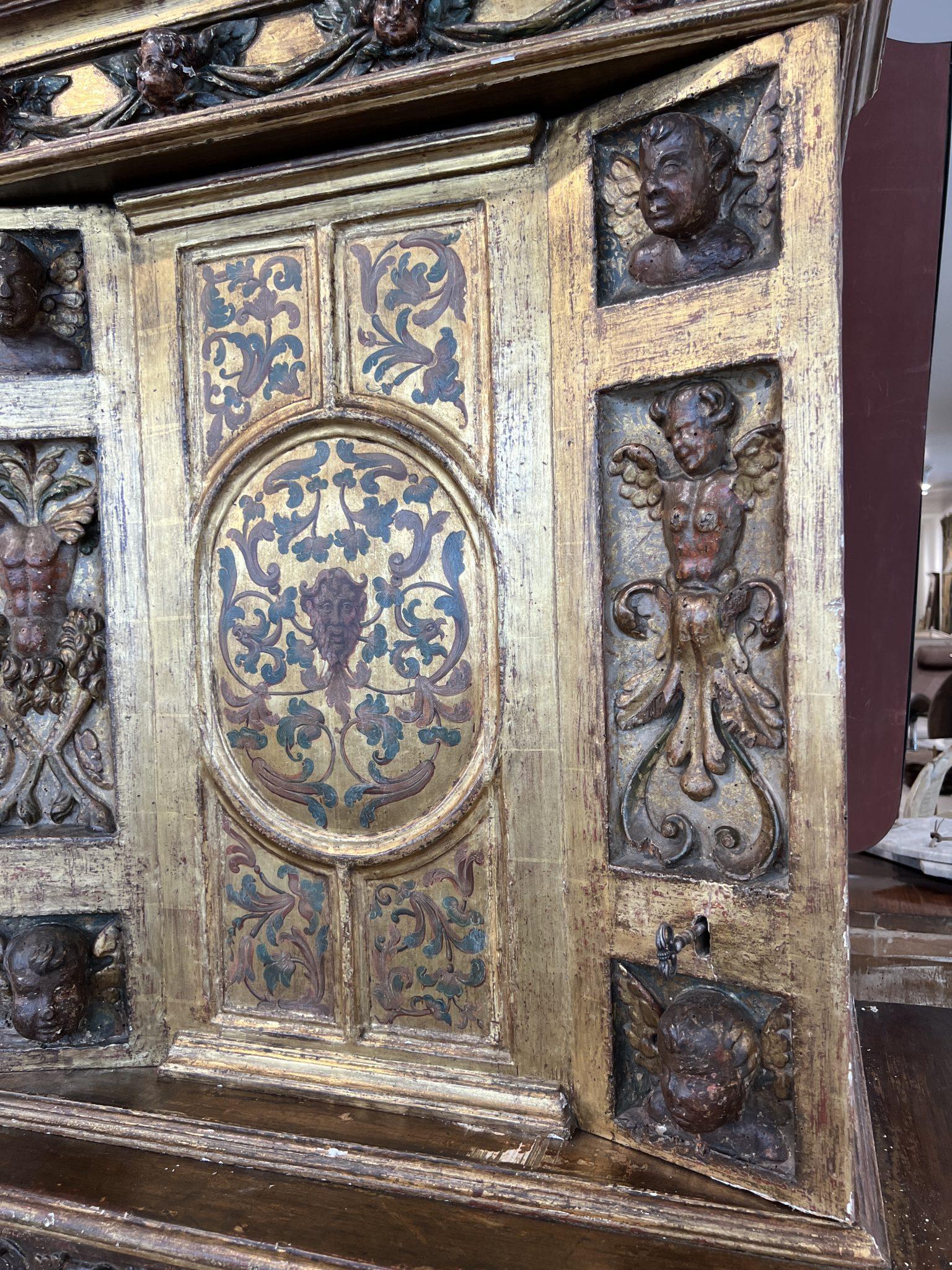 The wow factor is enormous with the extremely ornate carving and painting galore over every surface. Adorned with cherubs and mythical creatures, this cabinet would be the hero in any room.