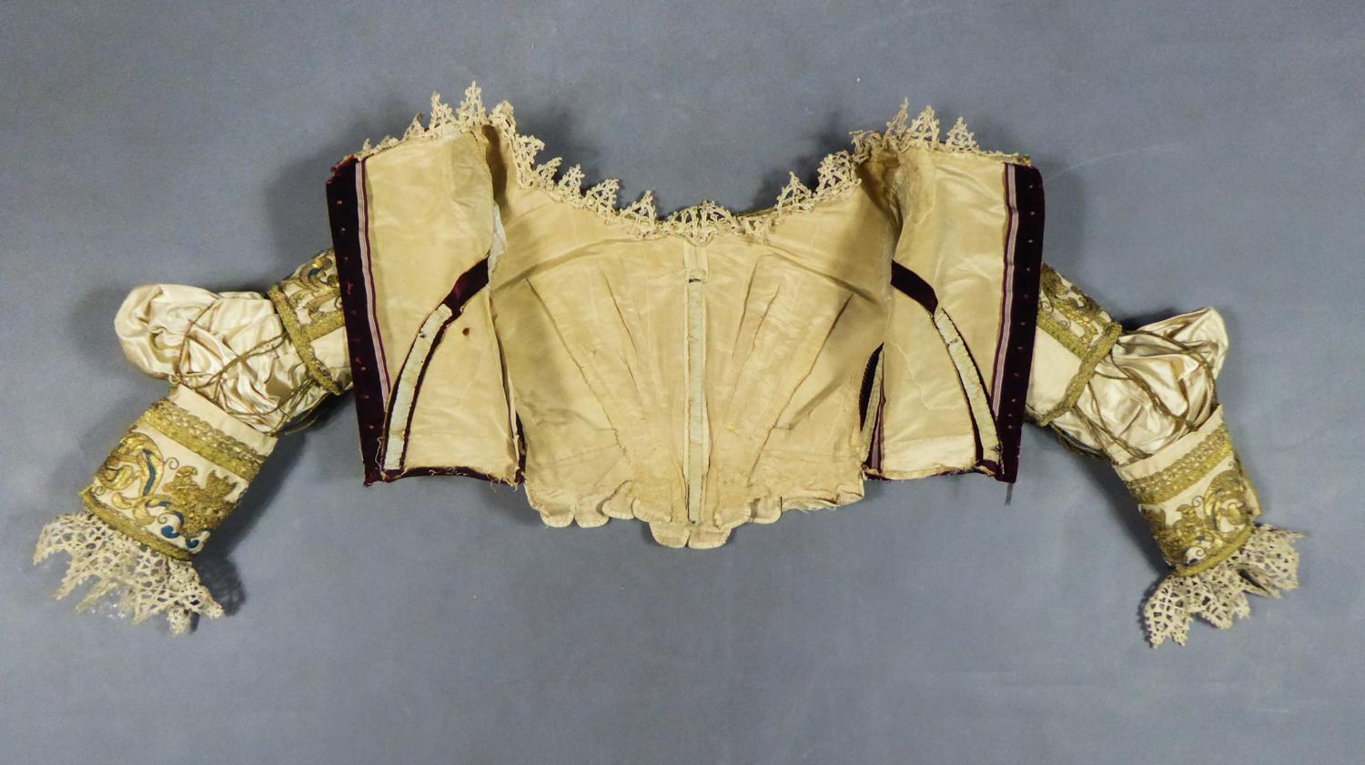 17th century reworked in the 19th century for fashion
France or Europe

Astonishing and rare bodice in embroidery with gold threads from the 17th century, reworked for Fashion probably around 1840. Original Gros de Tour cream background expertly
