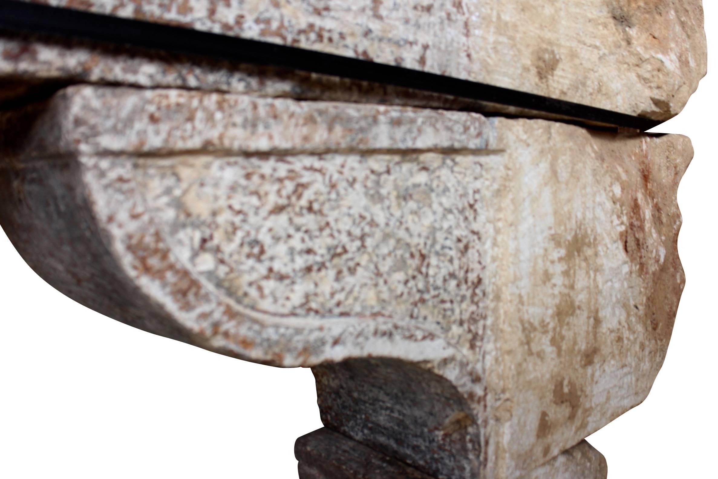 Es handelt sich um einen phänomenalen und völlig originalen Kaminsims aus Kalkstein mit außergewöhnlichen Resten der ursprünglichen Patina und mit sehr ungewöhnlichen Details. Die Gesimse sind wie originale Außenstürze ausgearbeitet, um die Front