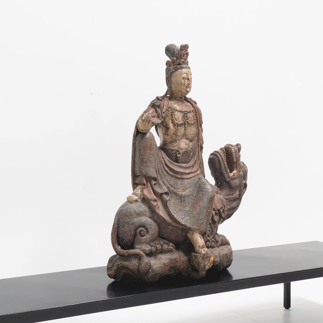 Beautiful wooden statue showing Guanyin, the Chinese interpretation of the bodhisattva. The Guanyin shown here sat on the back of a dragon.

The wood carving is from the 17th Century with its original polychrome. It's quit big with a beautiful