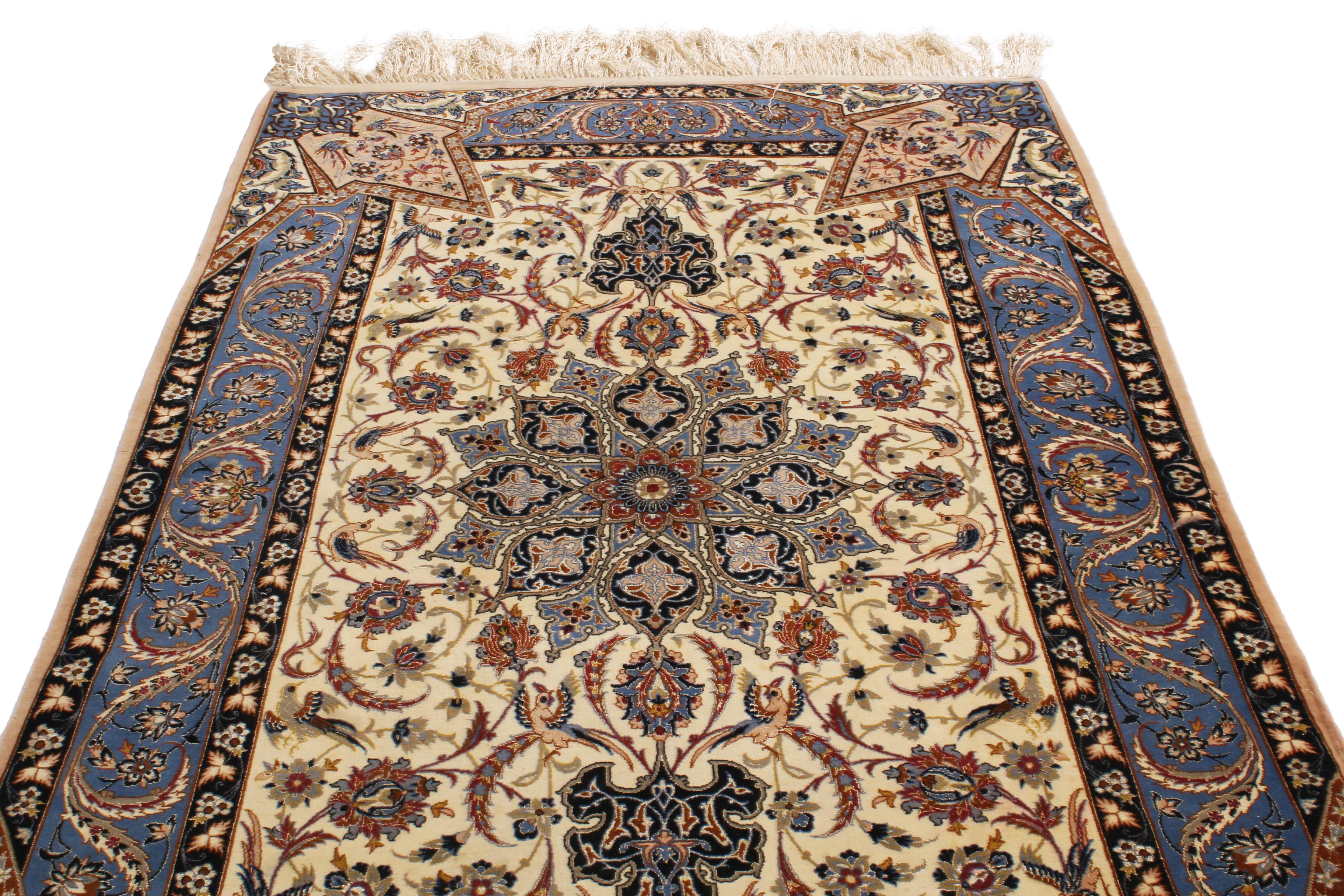 Hand knotted in high-quality wool and naturally luminous silk originating from Persia in the 1970s, this Isfahan Persian rug was inspired from a remarkable 17th century field design with unique, dimensional border permeating the field in the form of