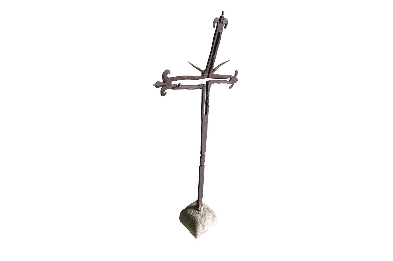 A simply beautiful 17th century cross from the Catalan region of Spain. Constructed from hand forged iron, resting in its stone base. A wonderful accent piece for any interior or exterior.
