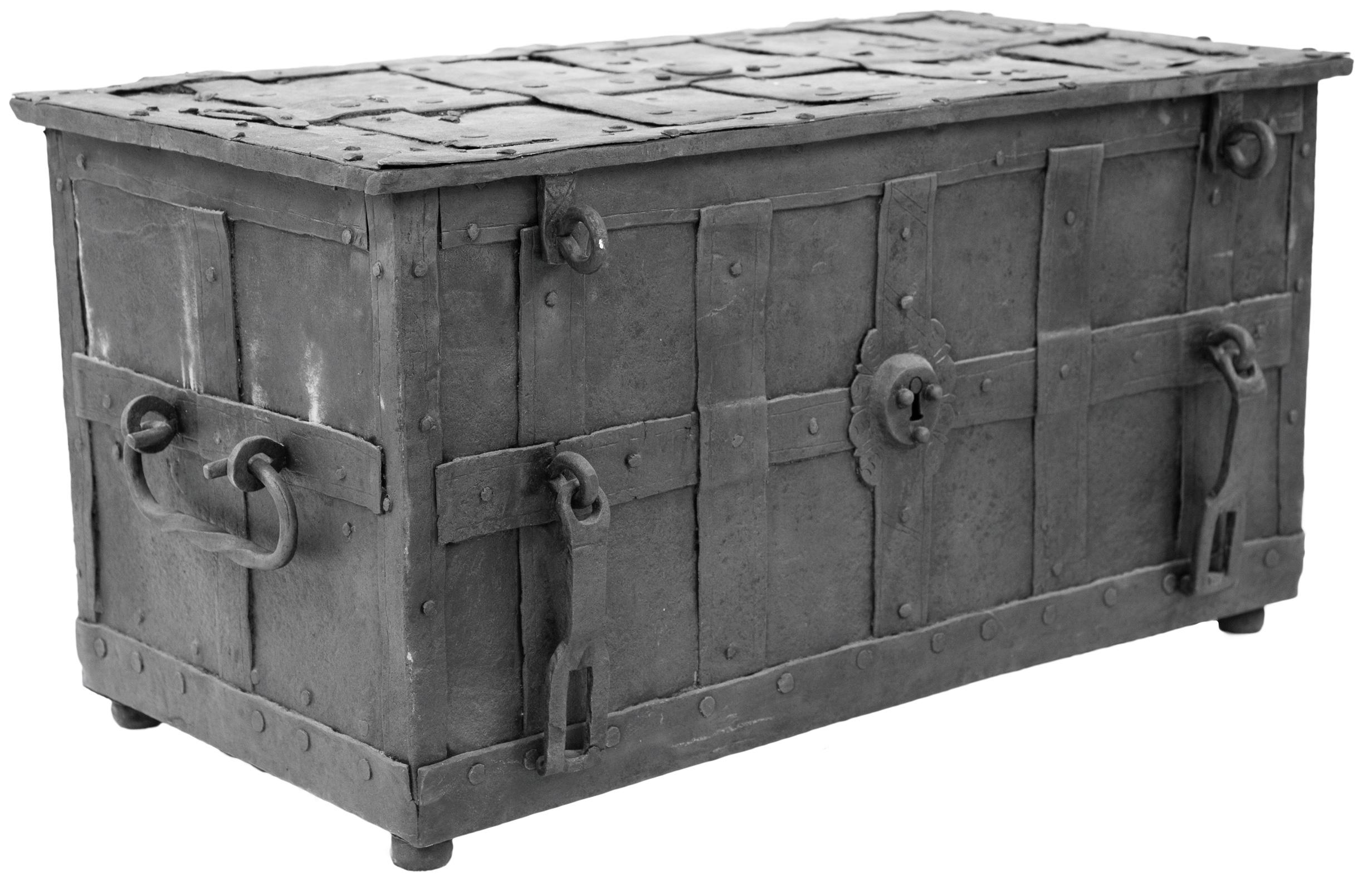 A 17th century iron strong box. The rectangular chest clad in studded, interwoven straps incorporating an ornamental escutcheon for a faux lock to the front flanked by padlock hasps, with a sliding flap concealing a keyhole with key to the top. The